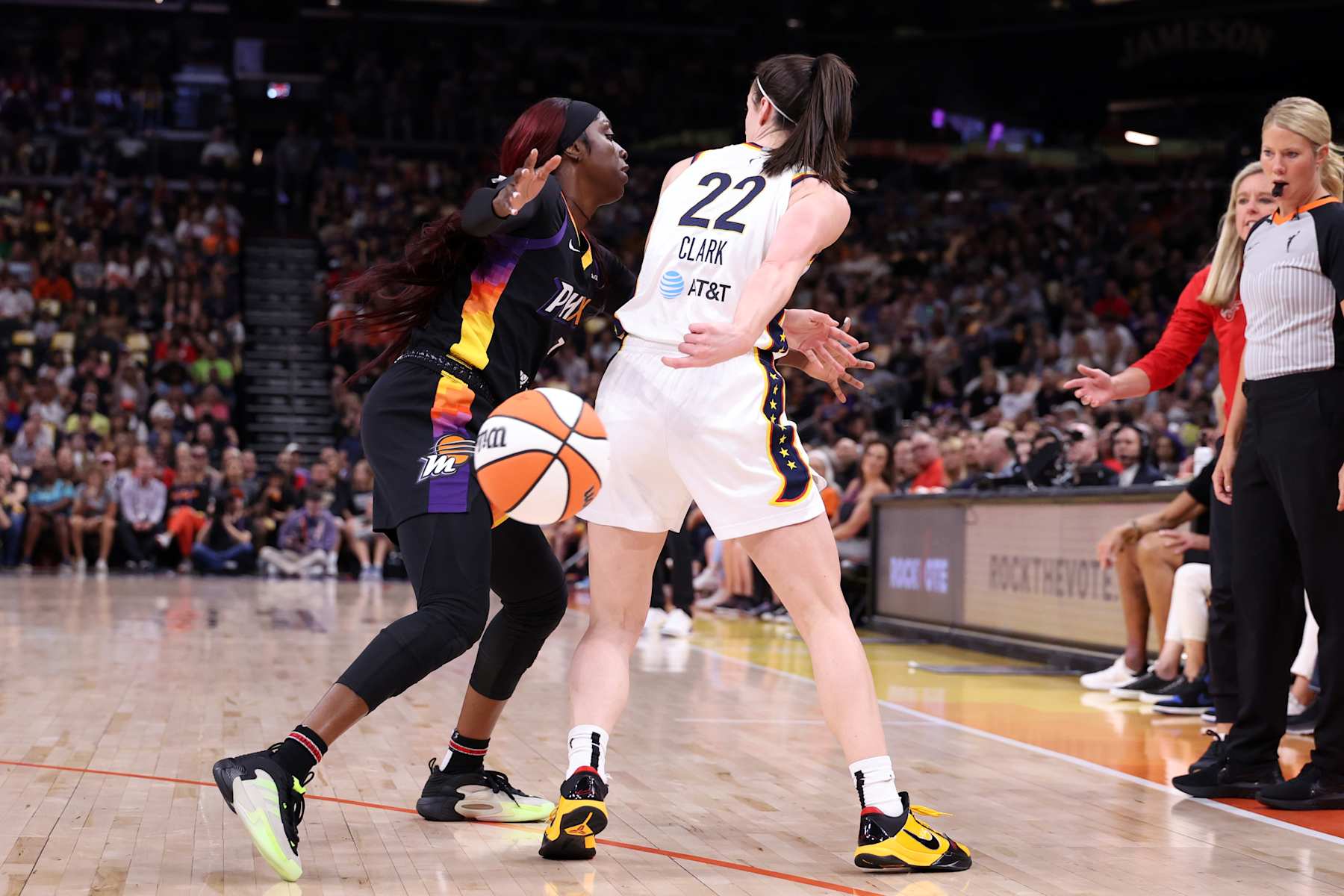 PHOENIX, ARIZONA - JUNE 30: Guard Caitlin Clark #22 of the Indiana Fever passes around guard Kahleah Copper #2 of the Phoenix Mercury during the game at Footprint Center on June 30, 2024 in Phoenix, Arizona. The Fever defeated the Mercury 88-82. NOTE TO USER: User expressly acknowledges and agrees that, by downloading and or using this photograph, User is consenting to the terms and conditions of the Getty Images License Agreement. (Photo by Chris Coduto/Getty Images)