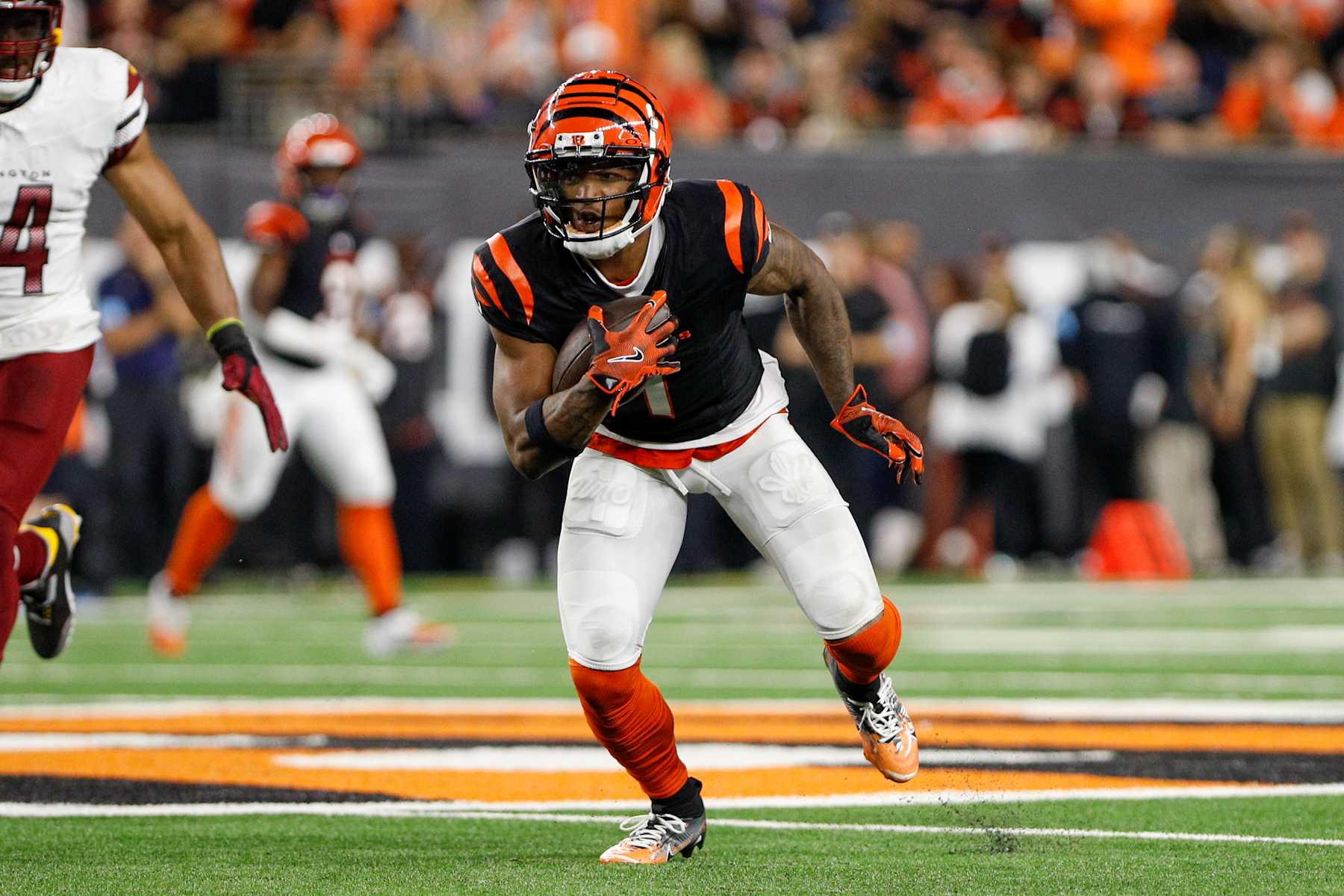 CINCINNATI, OH - SEPTEMBER 23: Cincinnati Bengals wide receiver Ja'Marr Chase (1) carries the ball during the game against the Washington Commanders and the Cincinnati Bengals on September 23, 2024, at Paycor Stadium in Cincinnati, OH. (Photo by Ian Johnson/Icon Sportswire via Getty Images)