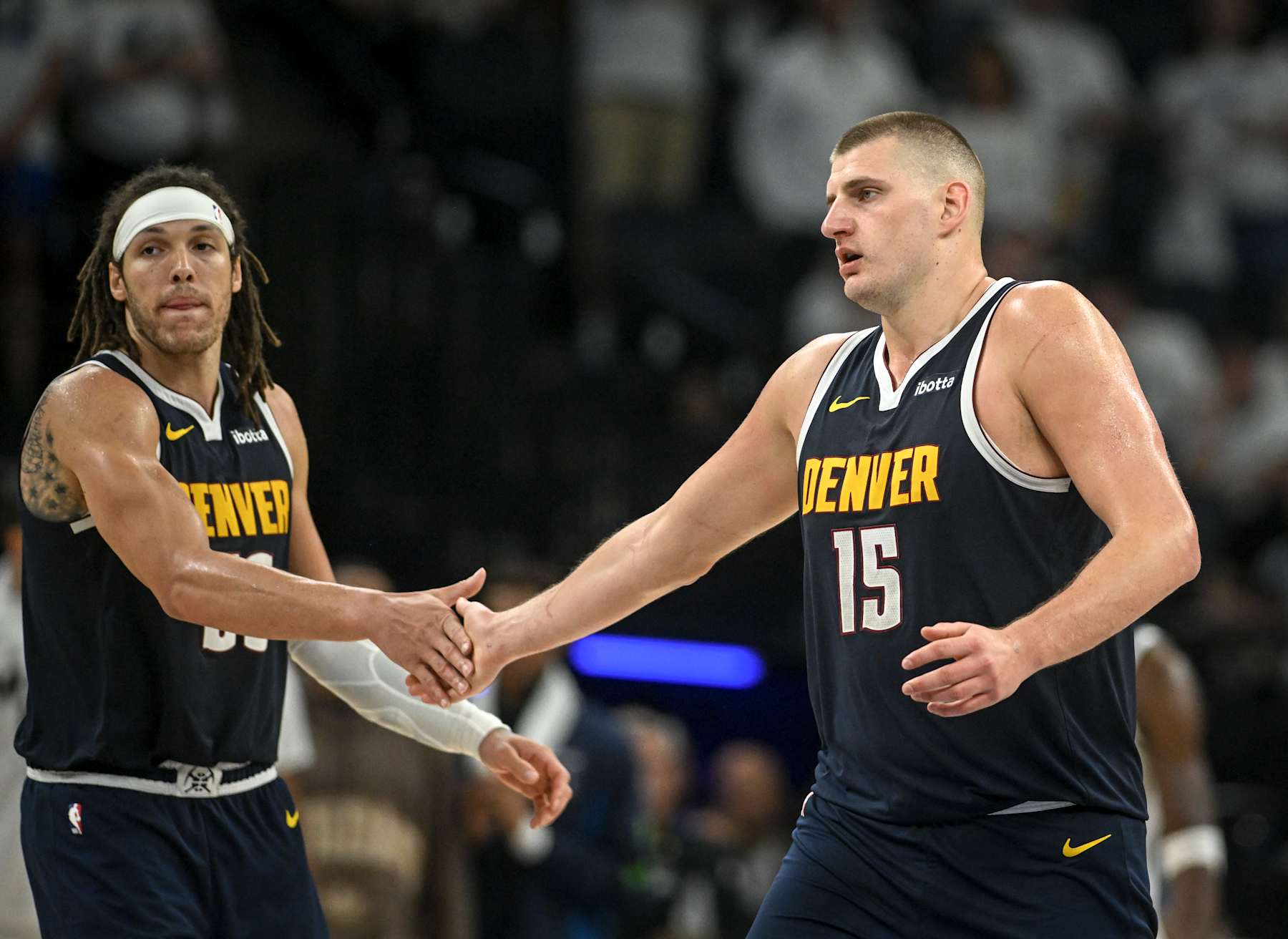 MINNEAPOLIS , MN - MAY 12: Nikola Jokic (15) of the Denver Nuggets shakes hands with Aaron Gordon (50) during the fourth quarter of the Nuggets' 115-107 win over the Minnesota Timberwolves at Target Center in Minneapolis, Minnesota on Sunday, May 12, 2024. (Photo by AAron Ontiveroz/The Denver Post)