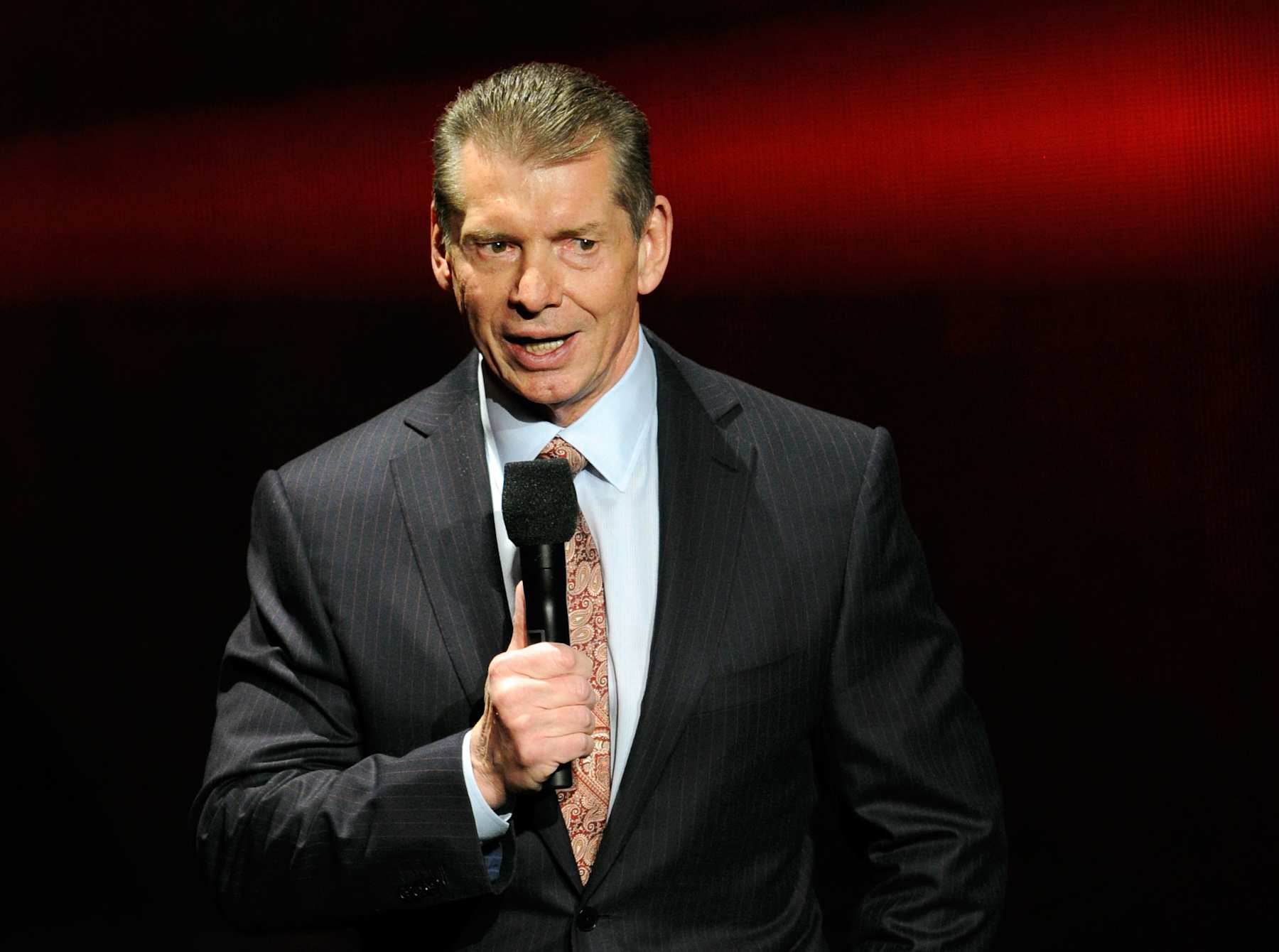 LAS VEGAS, NV - JANUARY 08: WWE Chairman and CEO Vince McMahon speaks at a news conference announcing the WWE Network at the 2014 International CES at the Encore Theater at Wynn Las Vegas on January 8, 2014 in Las Vegas, Nevada. The network will launch on February 24, 2014 as the first-ever 24/7 streaming network, offering both scheduled programs and video on demand. The USD 9.99 per month subscription will include access to all 12 live WWE pay-per-view events each year. CES, the world's largest annual consumer technology trade show, runs through January 10 and is expected to feature 3,200 exhibitors showing off their latest products and services to about 150,000 attendees. (Photo by Ethan Miller/Getty Images)