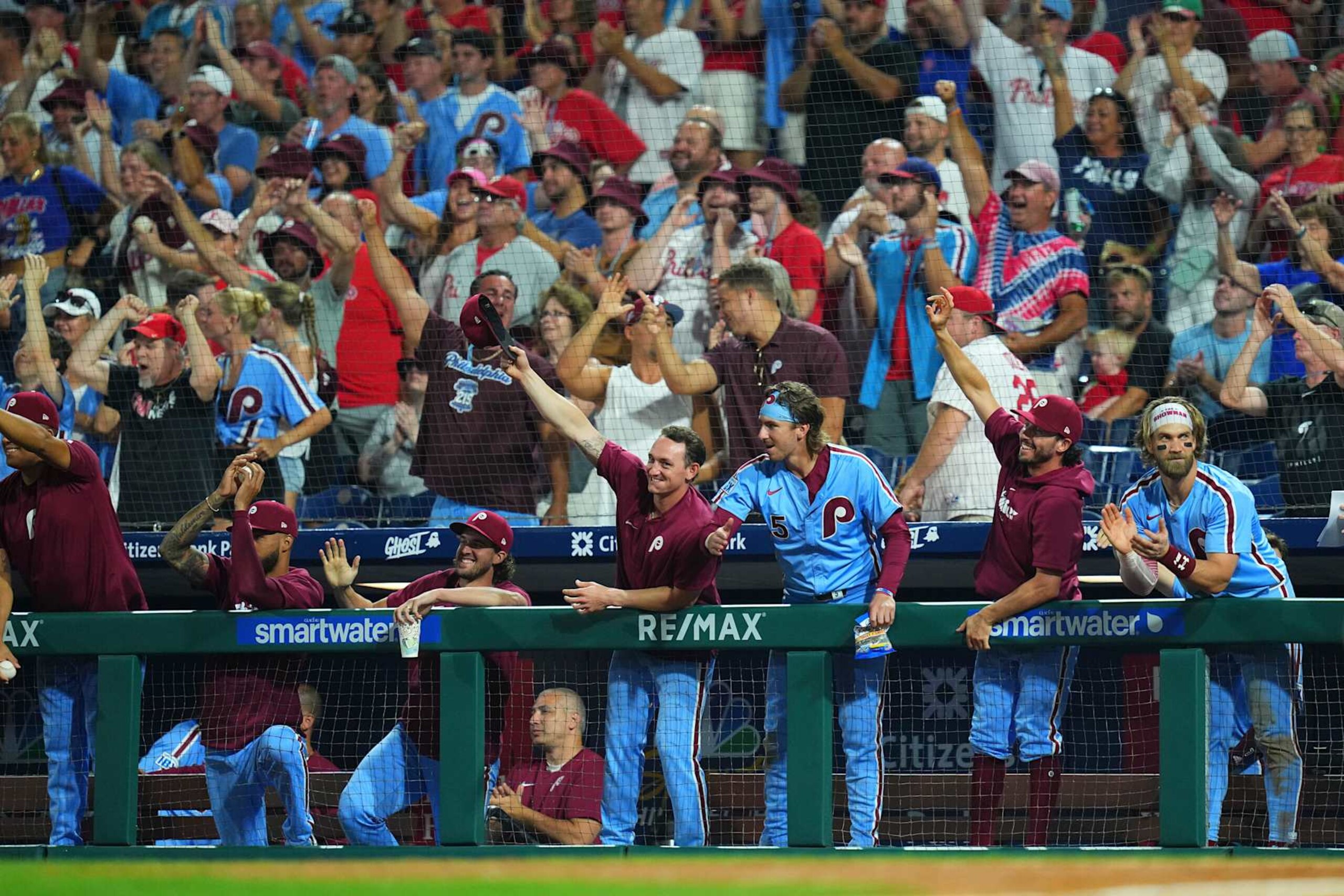 PHILADELPHIA, PENNSYLVANIA - AUGUST 15: (L-R) Cristopher Sánchez #61, Aaron Nola #27, Austin Hays #9, Bryson Stott #5, Garrett Stubbs #21, and Bryce Harper #3 of the Philadelphia Phillies react after Weston Wilson #37 of the Philadelphia Phillies hit a double for the cycle in the bottom of the eighth inning against the Washington Nationals at Citizens Bank Park on August 15, 2024 in Philadelphia, Pennsylvania. The Phillies defeated the Nationals 13-3. (Photo by Mitchell Leff/Getty Images)