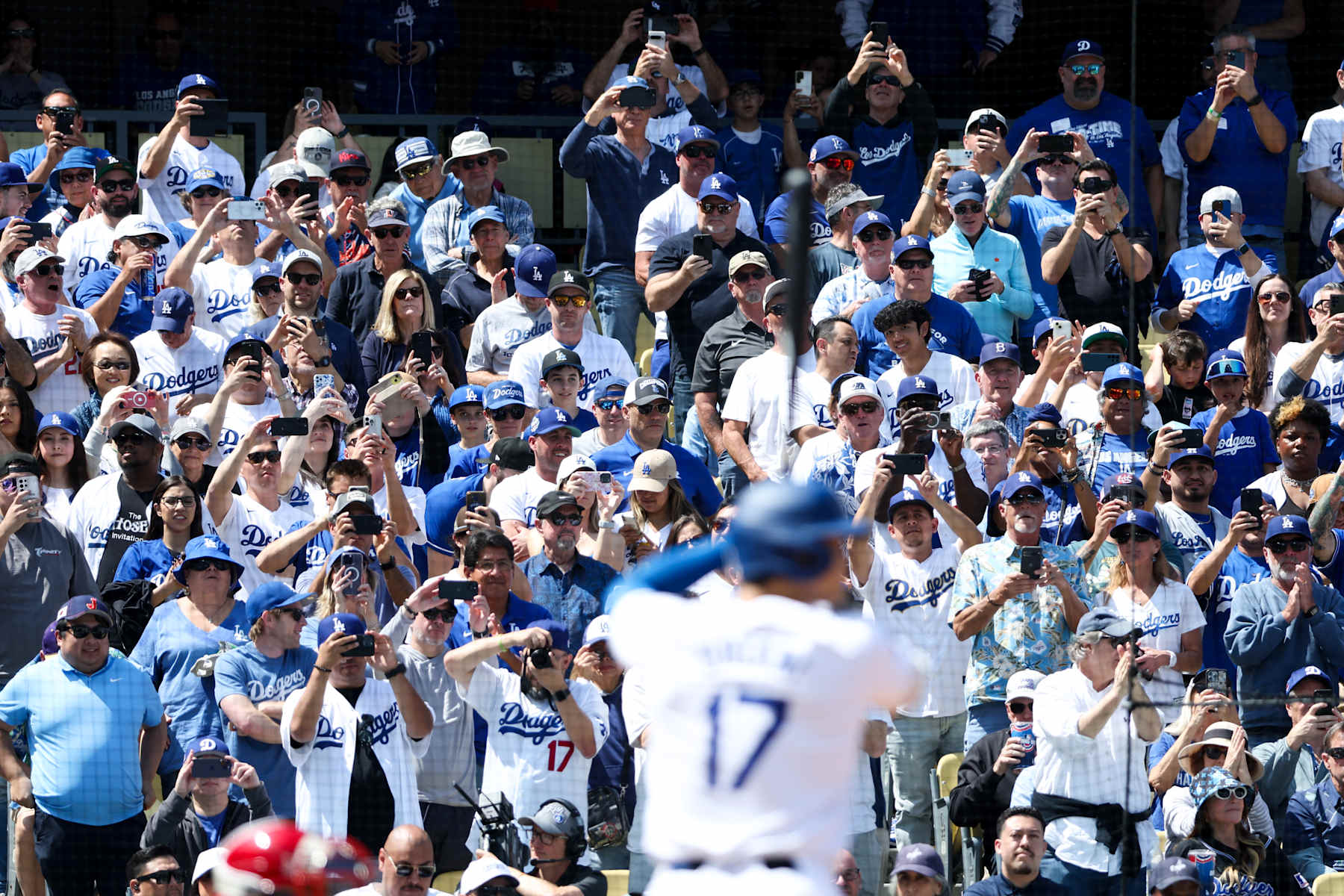 LOS ANGELES, CA - MARCH 28: Fans hold out their cellphones to watch Los Angeles Dodgers designated hitter Shohei Ohtani (17) at bat during the first inning against the St. Louis Cardinals in Dodgers Stadium on Thursday, March 28, 2024 in Los Angeles, CA. (Wally Skalij / Los Angeles Times via Getty Images)