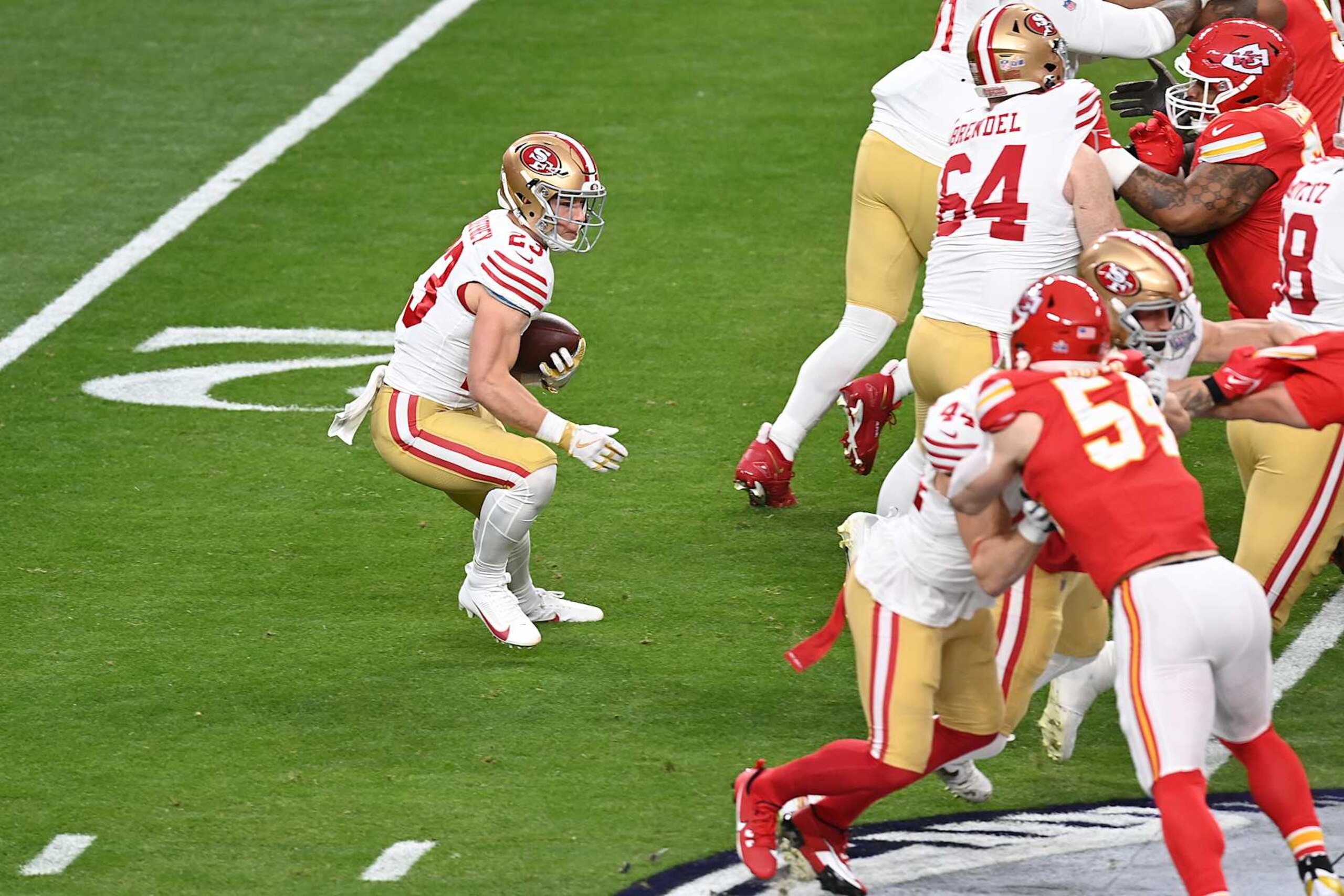 LAS VEGAS, NEVADA - FEBRUARY 11: Christian McCaffrey #23 of the San Francisco 49ers carries the ball against the Kansas City Chiefs in the first half during Super Bowl LVIII at Allegiant Stadium on February 11, 2024 in Las Vegas, Nevada. (Photo by Focus on Sport/Getty Images)