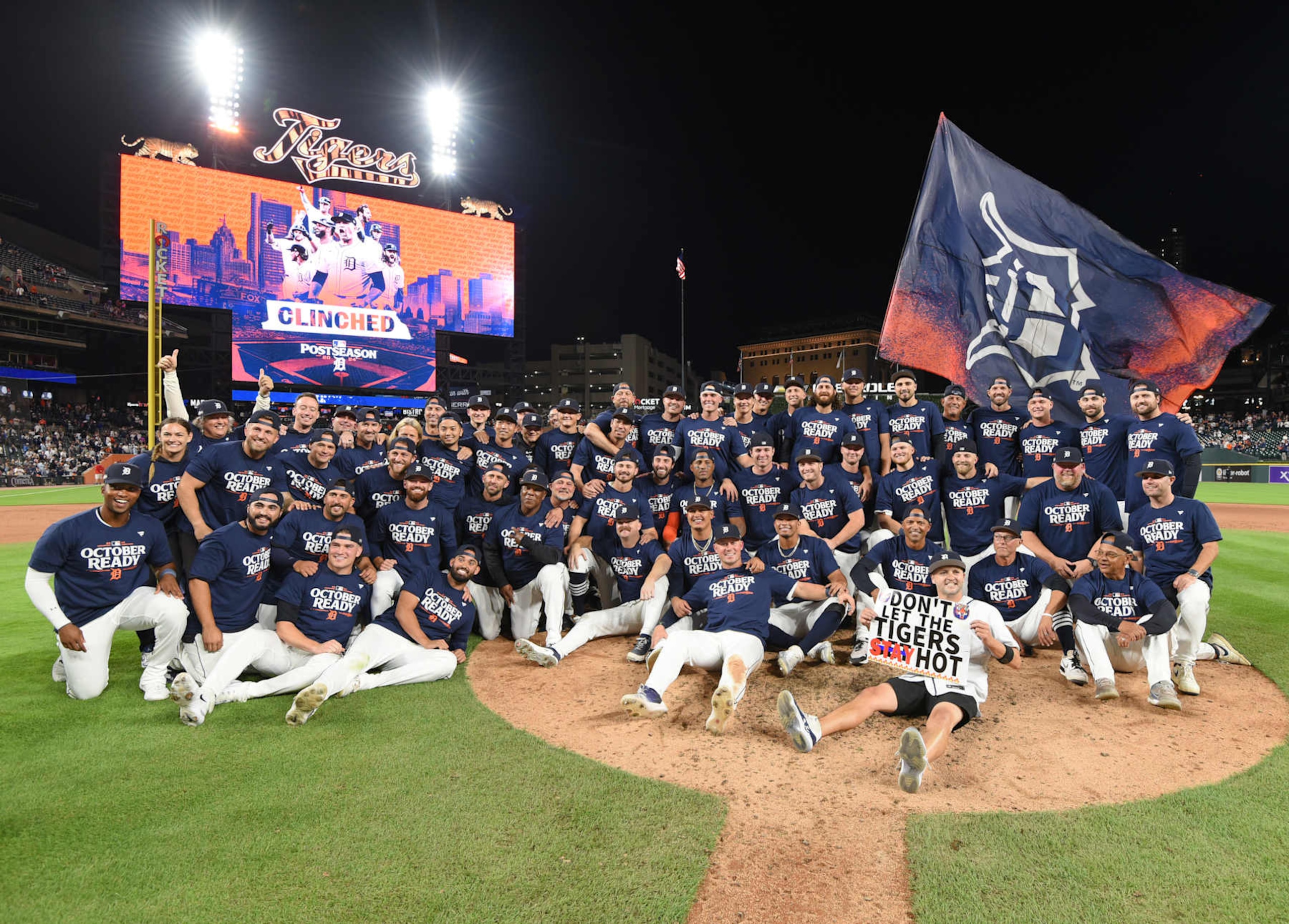 DETROIT, MI - SEPTEMBER 27:  Detroit Tigers players, coaches, staff, and a fan holding a sign pose for a team photo after the victory against the Chicago White Sox at Comerica Park on September 27, 2024 in Detroit, Michigan. The Tigers defeated the White Sox 4-1 to earn a postseason wild card berth.  (Photo by Mark Cunningham/MLB Photos via Getty Images)