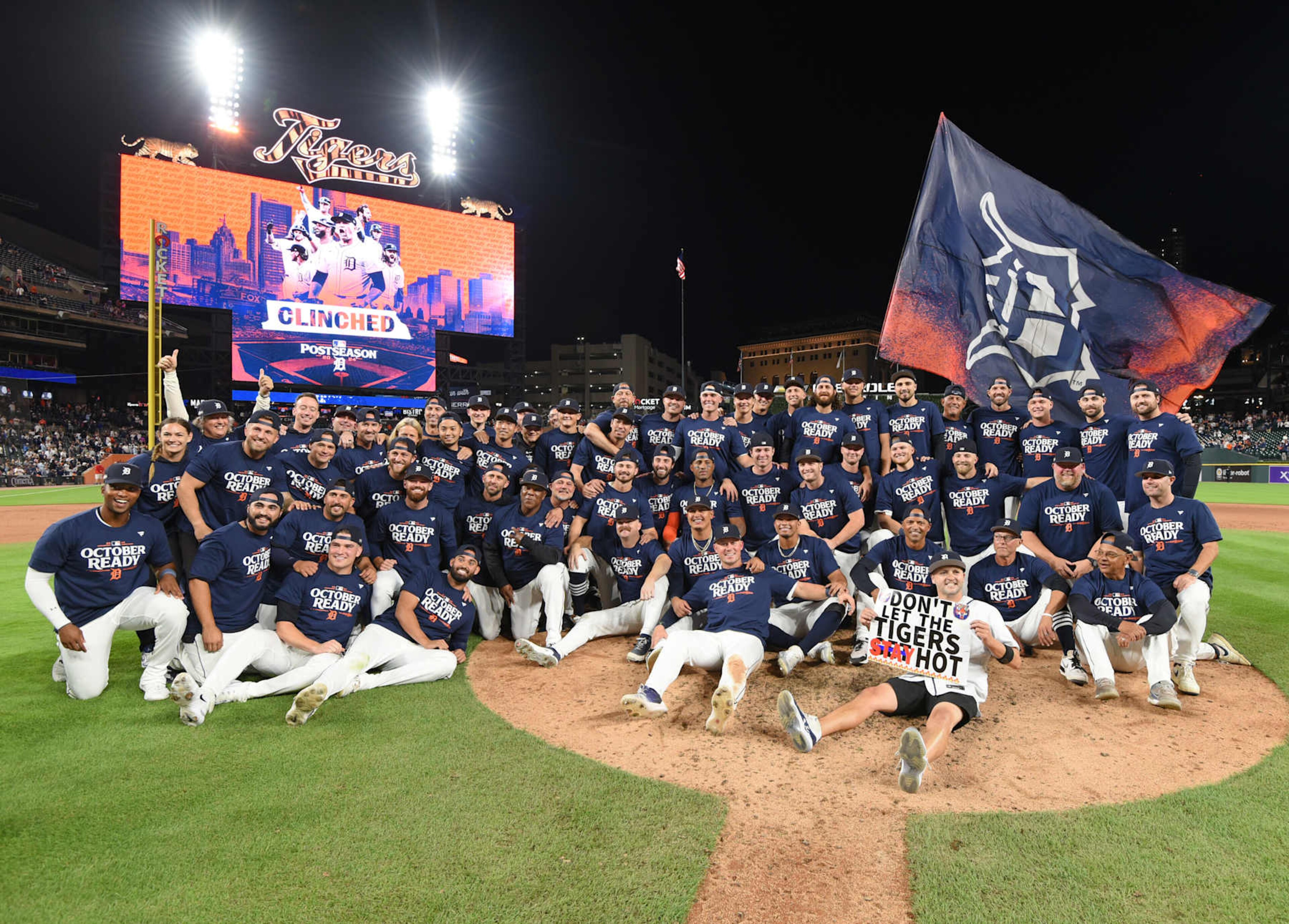 DETROIT, MI - SEPTEMBER 27:  Detroit Tigers players, coaches, staff, and a fan holding a sign pose for a team photo after the victory against the Chicago White Sox at Comerica Park on September 27, 2024 in Detroit, Michigan. The Tigers defeated the White Sox 4-1 to earn a postseason wild card berth.  (Photo by Mark Cunningham/MLB Photos via Getty Images)