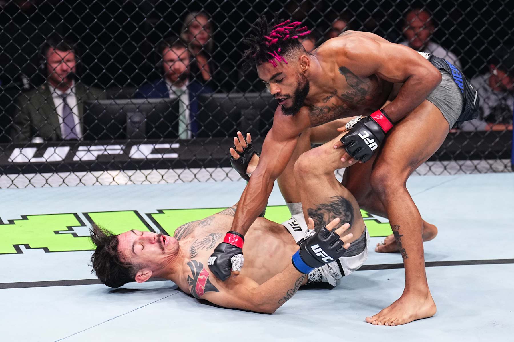 PARIS, FRANCE - SEPTEMBER 28: (R-L) Morgan Charriere of France punches Gabriel Miranda of Brazil in a featherweight fight during the UFC Fight Night event at The Accor Arena on September 28, 2024 in Paris, France. (Photo by Chris Unger/Zuffa LLC)