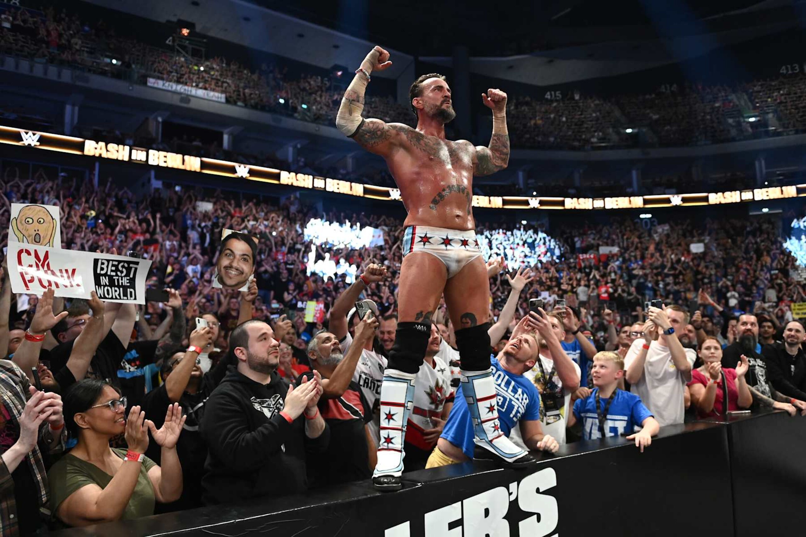 BERLIN, GERMANY - AUGUST 31: CM Punk celebrates his victory over Drew McIntyre (not pictured) with fans following their strap match at the WWE Bash in Berlin Premium Live Event at Uber Arena on August 31, 2024 in Berlin, Germany.  (Photo by WWE/Getty Images)