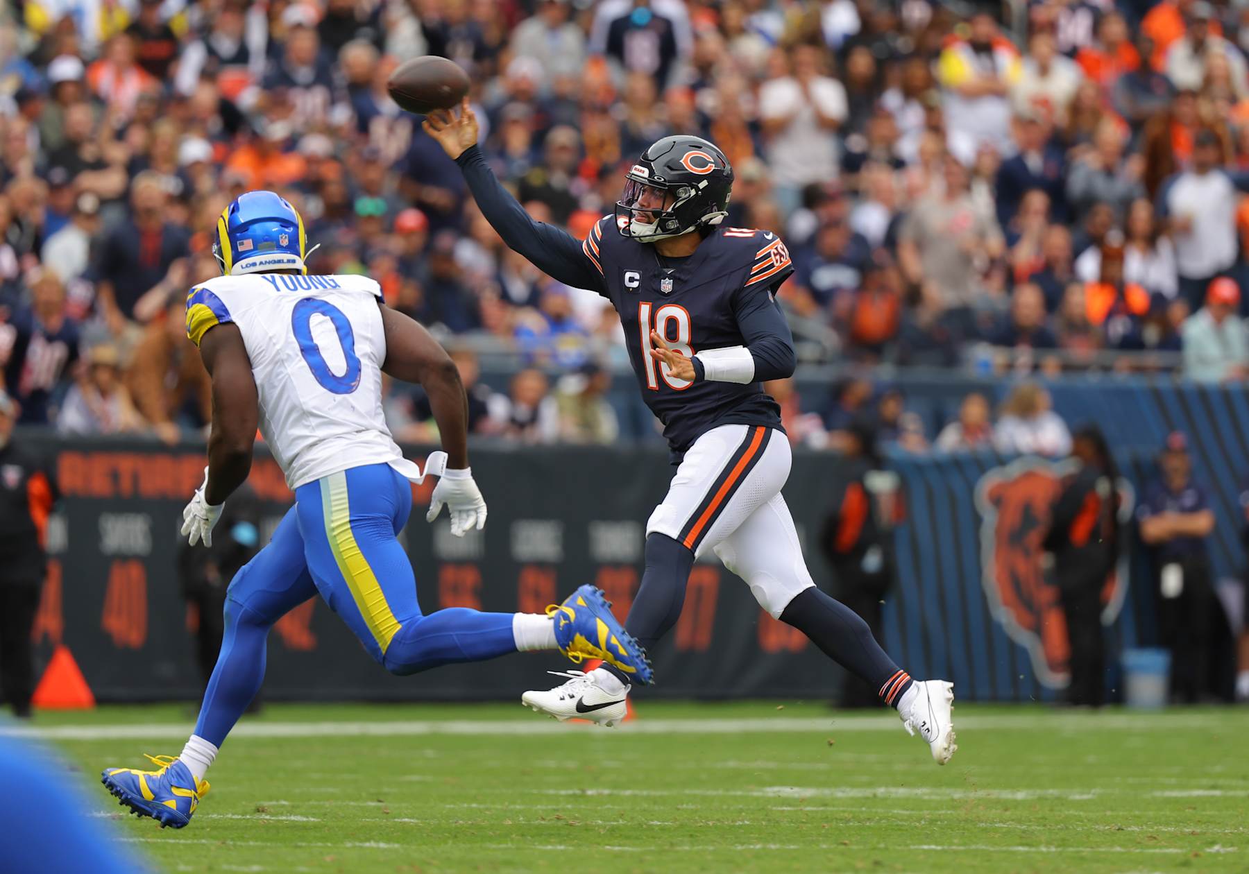 CHICAGO, IL - SEPTEMBER 29: Quarterback Caleb Williams (18) of the Chicago Bears throws while running during the first half against the Los Angeles Rams on September 29, 2024 at Soldier Field in Chicago, Illinois. (Photo by Melissa Tamez/Icon Sportswire via Getty Images)