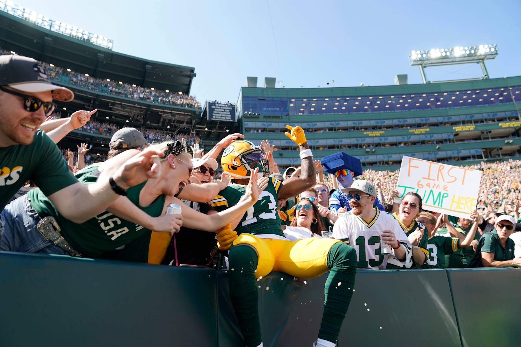 GREEN BAY, WISCONSIN - SEPTEMBER 15: Dontayvion Wicks #13 of the Green Bay Packers celebrates scoring a receiving touchdown against the Indianapolis Colts during the first quarter at Lambeau Field on September 15, 2024 in Green Bay, Wisconsin. (Photo by Patrick McDermott/Getty Images)