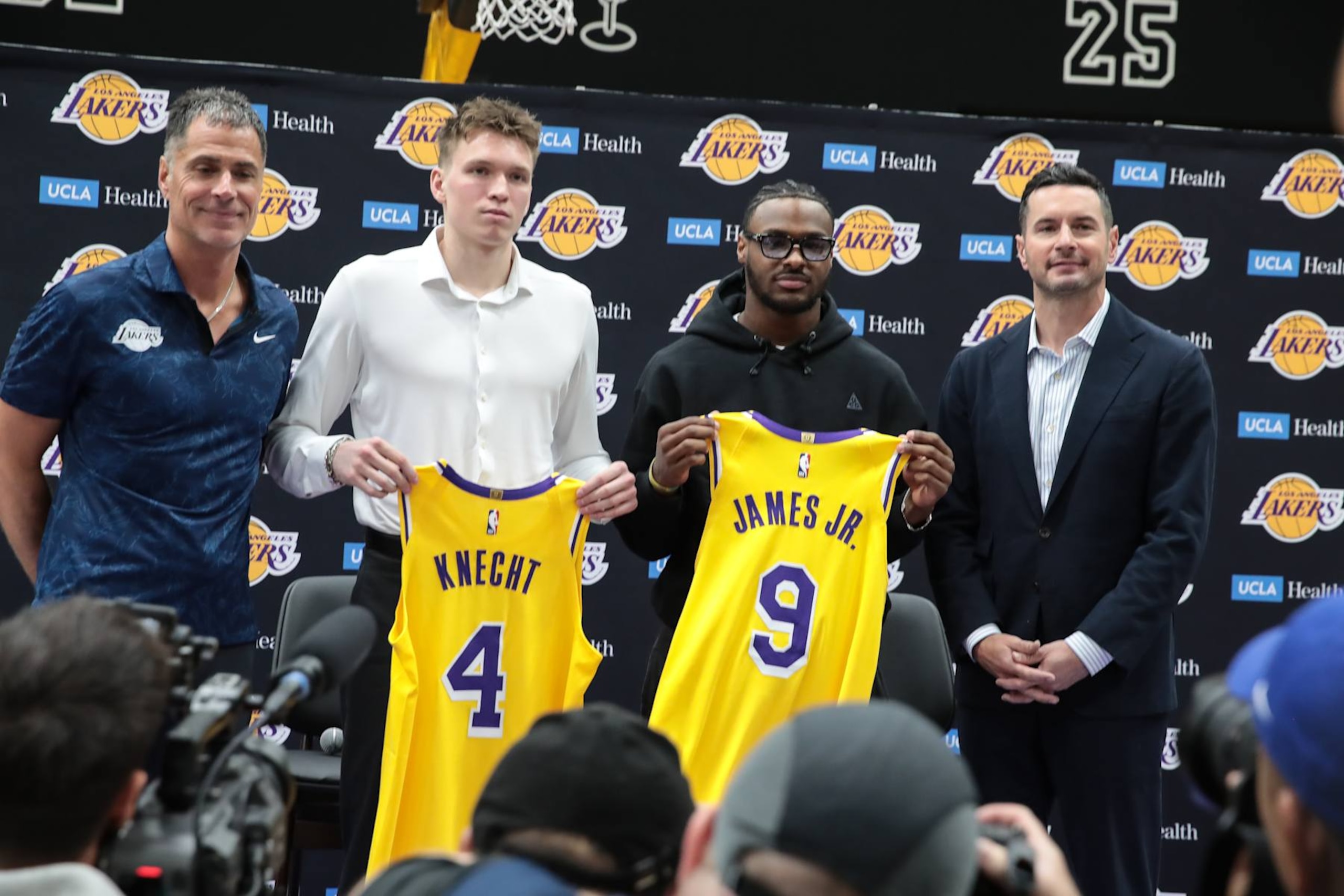 EL SEGUNDO, CA - JULY 02:  Los Angeles Lakers guard Dalton Knecht (4) and Los Angeles Lakers guard Bronny James (9) hold up thier jerseys flaked by Los Angeles Lakers general manager Rob Pelinka and Los Angeles Lakers head coach J.J. Redick during the Los Angeles Lakers welcome press conference for their NBA Draft picks on July 02, 2024, at UCLA Health Training Center in El Segundo, CA. (Photo by Jevone Moore/Icon Sportswire via Getty Images)