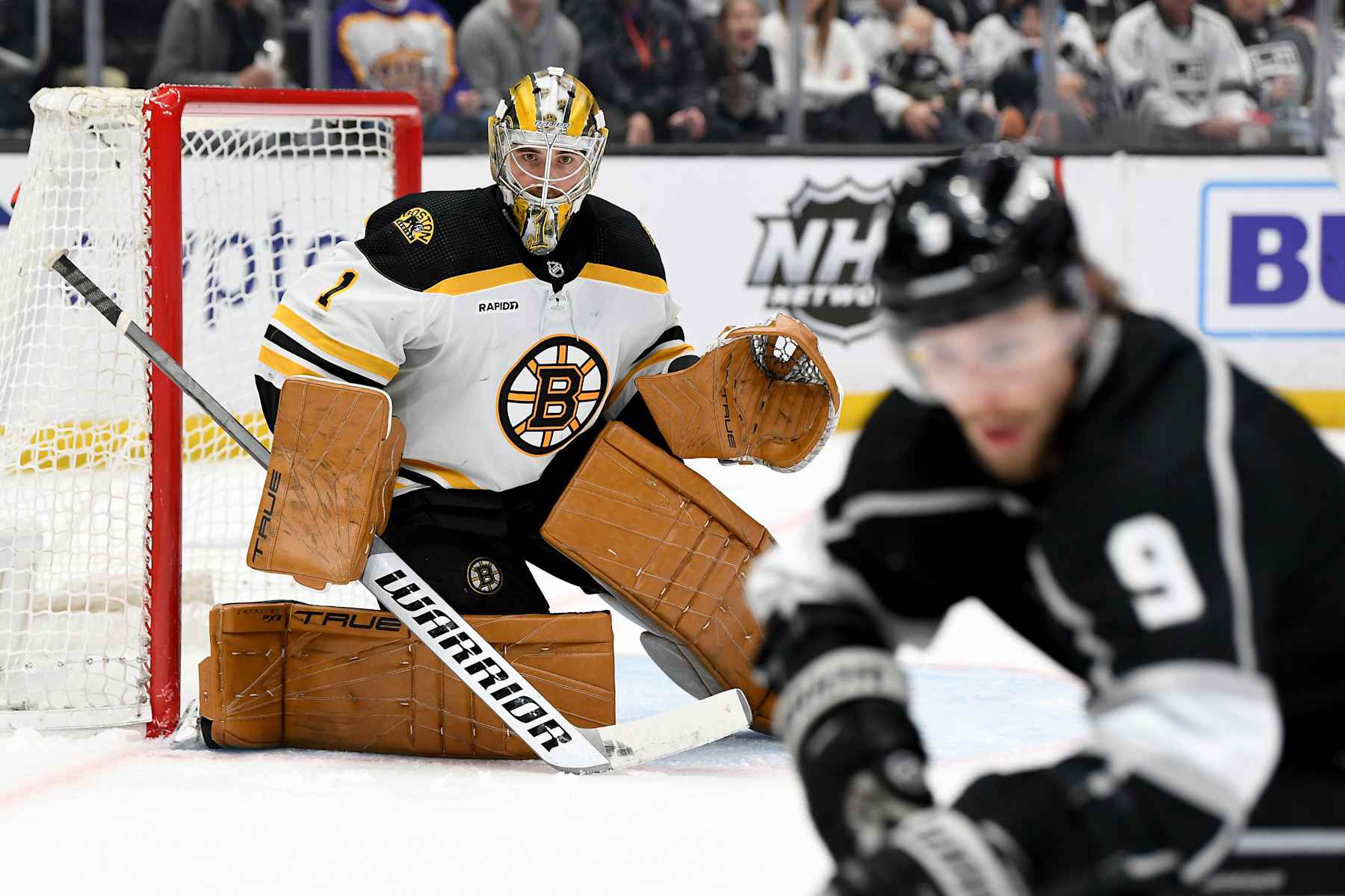 LOS ANGELES, CA - JANUARY 05: Boston Bruins Goalie Jeremy Swayman (1) watches the puck carrier Los Angeles Kings Winger Adrian Kempe (9) during an NHL game between the Boston Bruins and the Los Angeles Kings on January 5th, 2023, at the Crypto.com Arena in Los Angeles, CA. (Photo by Rob Curtis/Icon Sportswire via Getty Images)