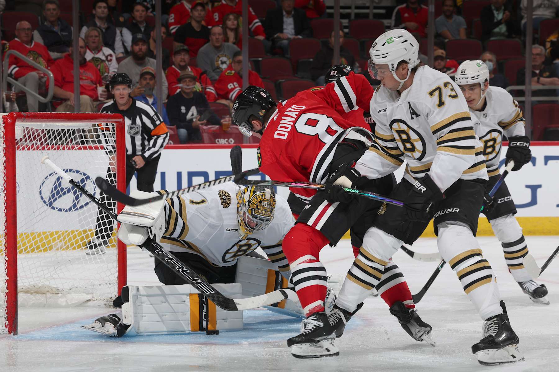CHICAGO, ILLINOIS - OCTOBER 24: Ryan Donato #8 of the Chicago Blackhawks attempts to score against goalie Jeremy Swayman #1 of the Boston Bruins and Charlie McAvoy #73 of the Boston Bruins during the second period at the United Center on October 24, 2023 in Chicago, Illinois. (Photo by Chase Agnello-Dean/NHLI via Getty Images)