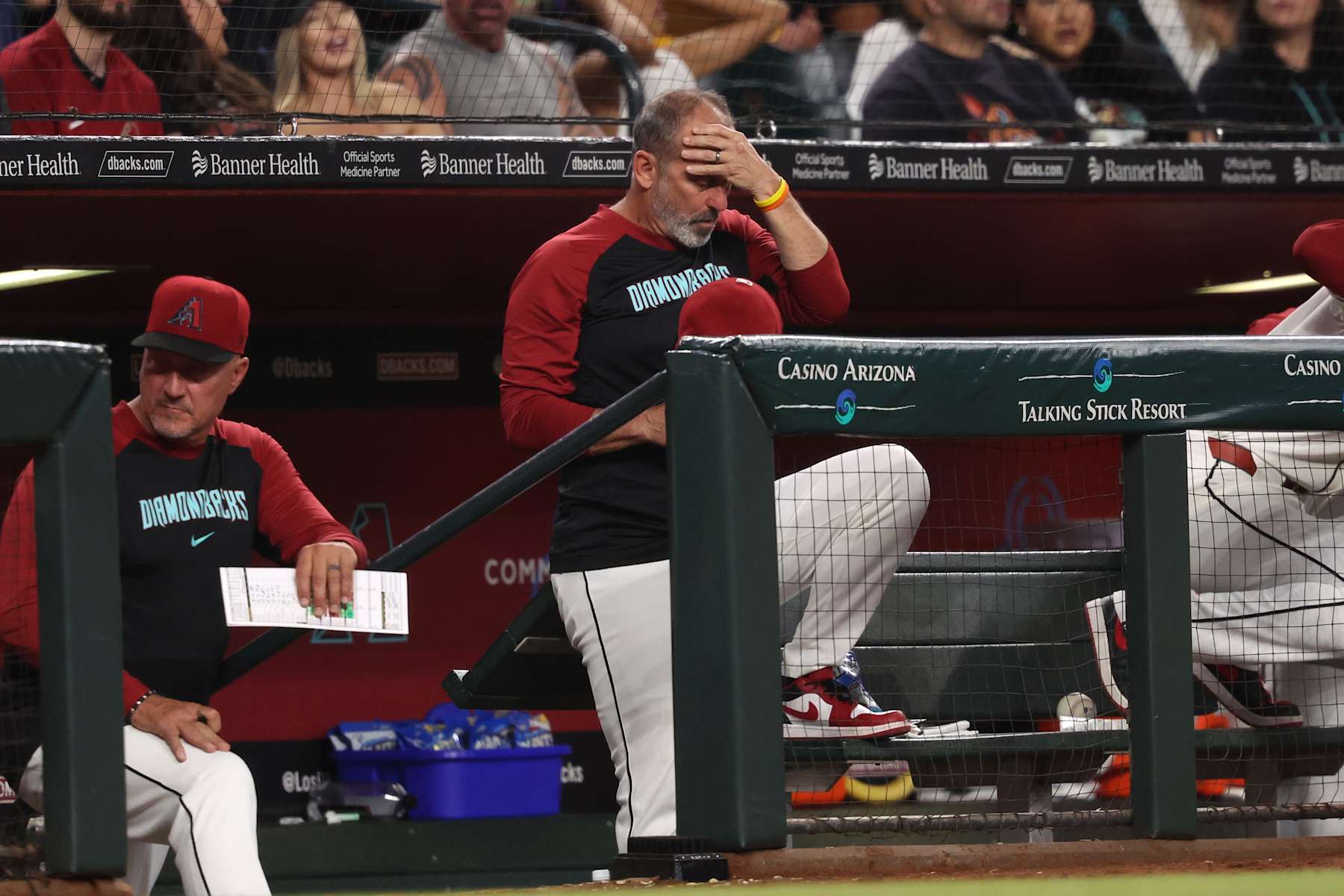 PHOENIX, ARIZONA - SEPTEMBER 27: Manager Torey Lovullo #17 of the Arizona Diamondbacks rubs his head during the fifth inning against the San Diego Padres at Chase Field on September 27, 2024 in Phoenix, Arizona. (Photo by Chris Coduto/Getty Images)