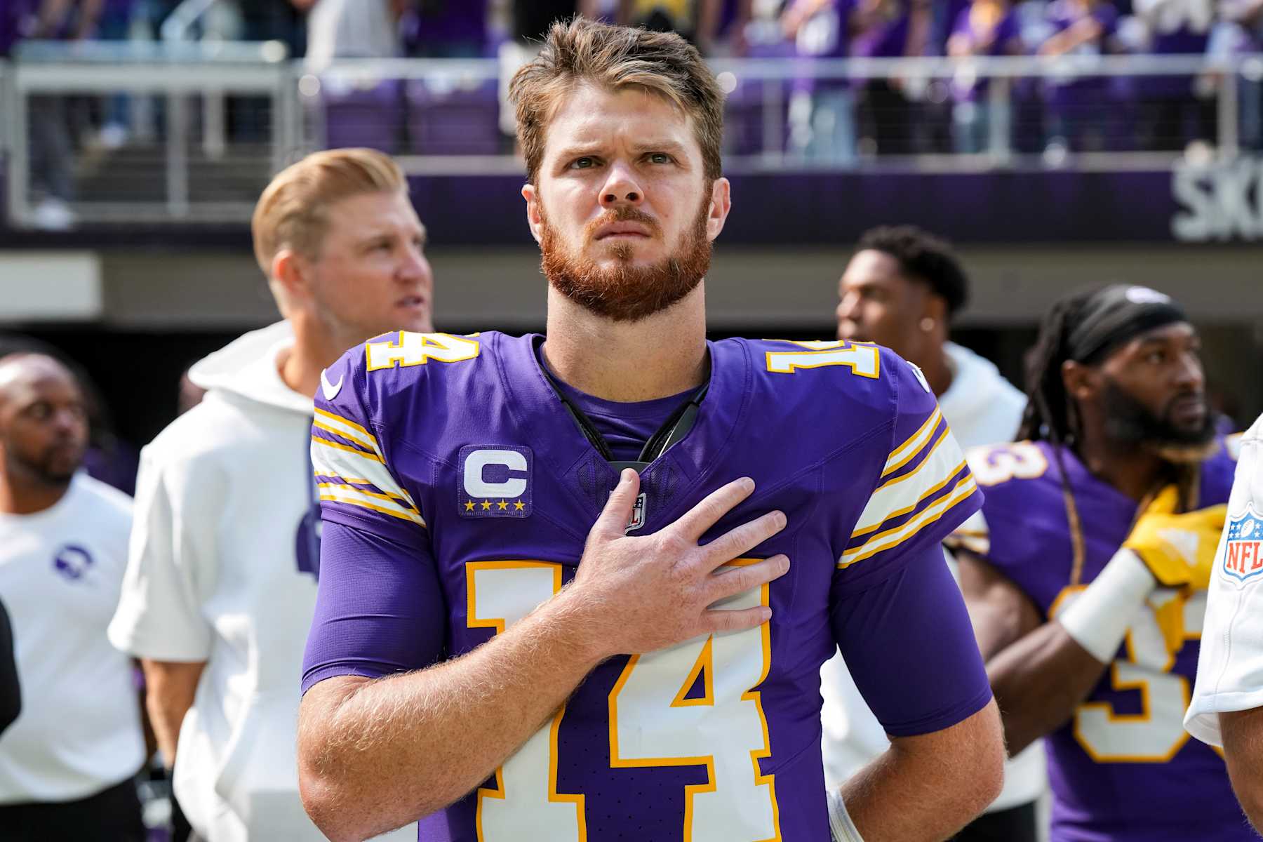 MINNEAPOLIS, MN - SEPTEMBER 22: Quarterback Sam Darnold #14 of the Minnesota Vikings stands on the sidelines during the national anthem prior to an NFL football game against the Houston Texans, at U.S. Bank Stadium on September 22, 2024 in Minneapolis, Minnesota. (Photo by Todd Rosenberg/Getty Images)