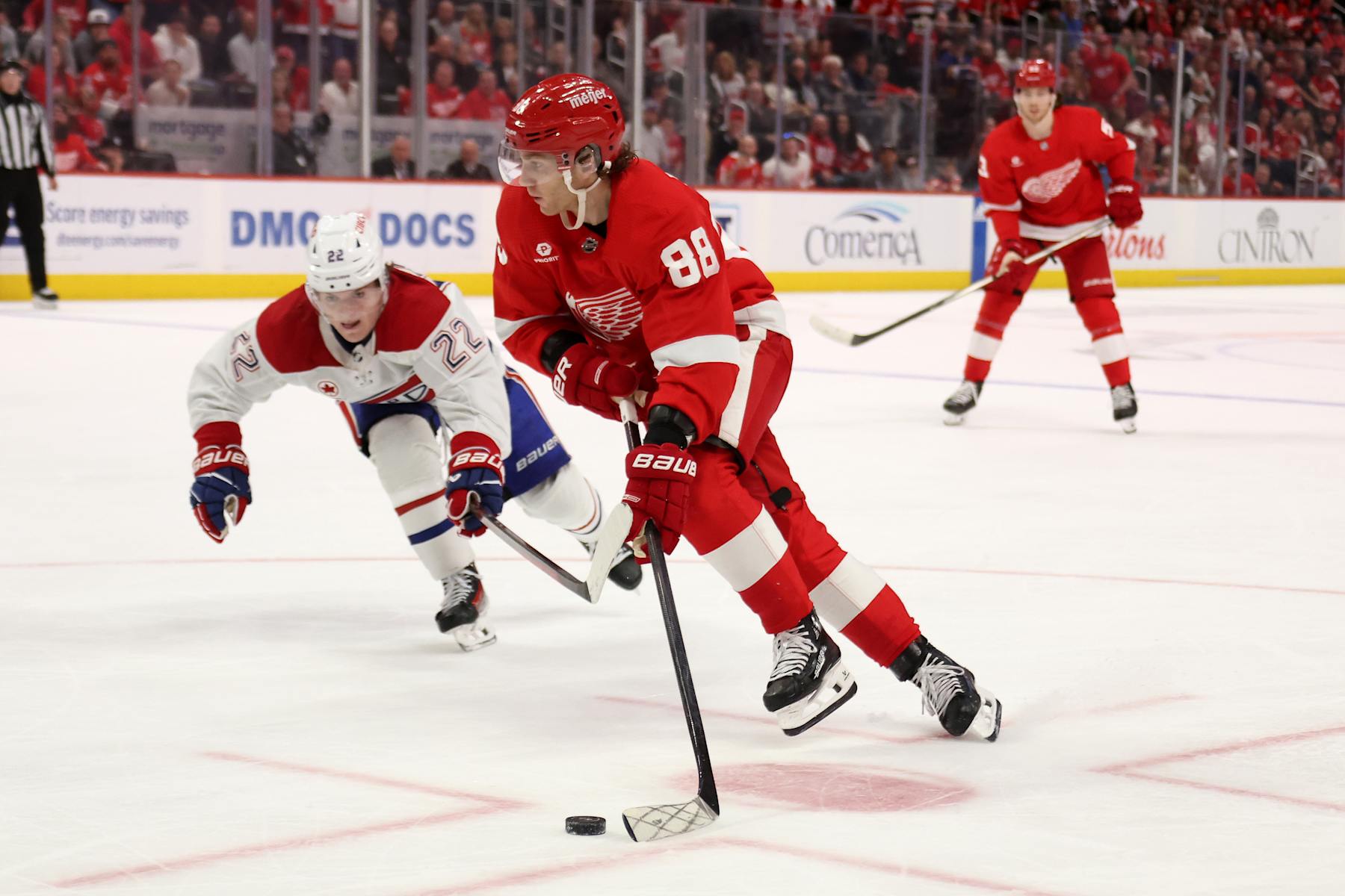 DETROIT, MICHIGAN - APRIL 15: Patrick Kane #88 of the Detroit Red Wings tries to get around the stick of Cole Caufield #22 of the Montreal Canadiens in overtime at Little Caesars Arena on April 15, 2024 in Detroit, Michigan. Detroit won the game 5-4 in overtime. (Photo by Gregory Shamus/Getty Images)