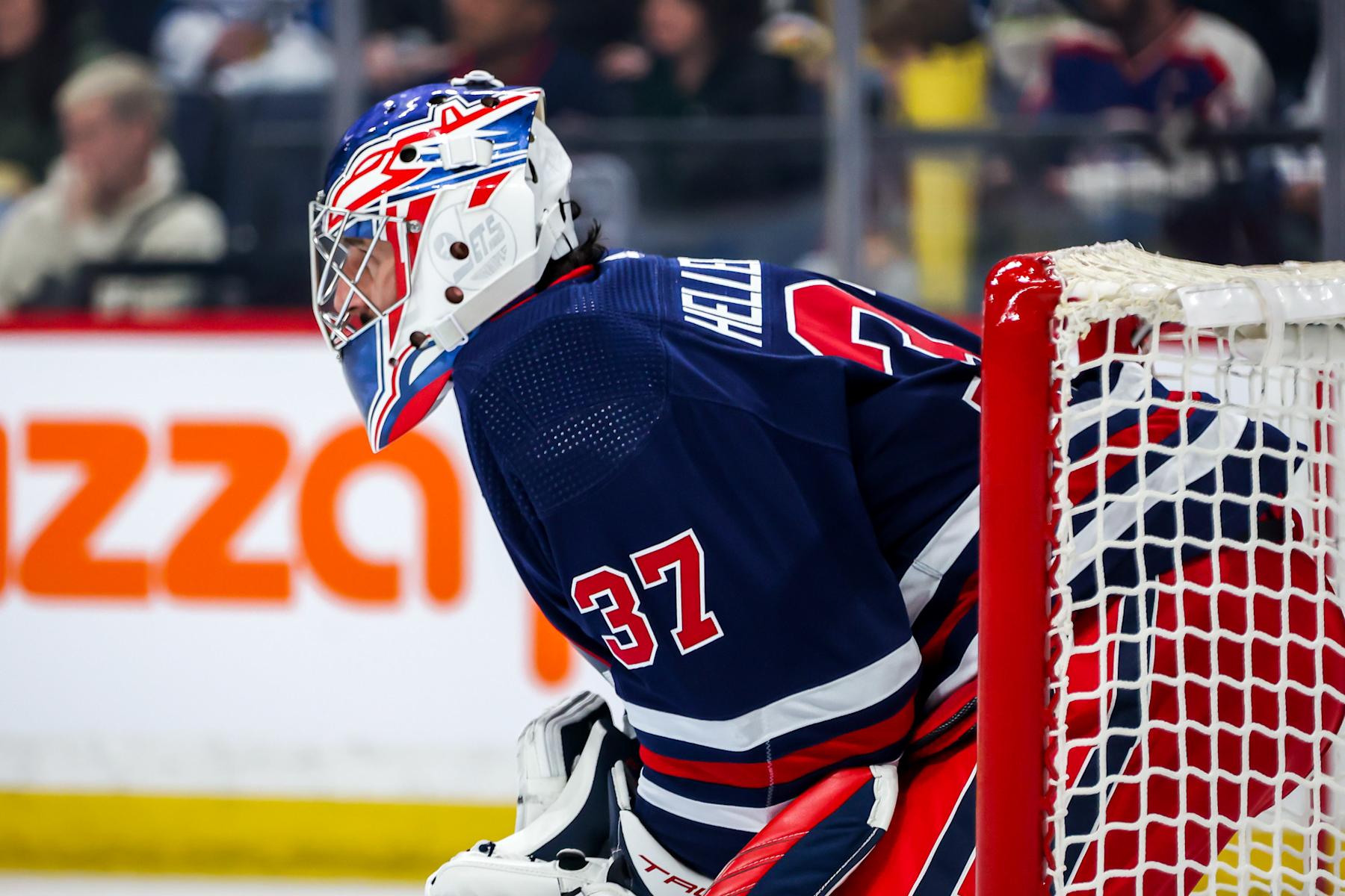 WINNIPEG, CANADA - MARCH 28: Goaltender Connor Hellebuyck #37 of the Winnipeg Jets looks on during a first period stoppage in play against the Vegas Golden Knights at the Canada Life Centre on March 28, 2024 in Winnipeg, Manitoba, Canada. (Photo by Jonathan Kozub/NHLI via Getty Images)