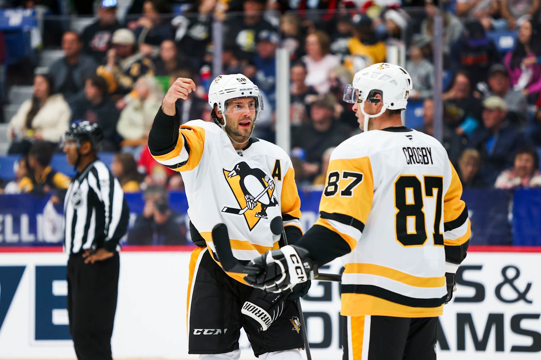 SUDBURY, CANADA - SEPTEMBER 29: Kris Letang #58 and Sydney Crosby #87 of the Pittsburgh Penguins interact during the second period of the NHL Kraft Hockeyville pre-season game against the Ottawa Senators at Sudbury Community Arena on September 29, 2024 in Sudbury, Ontario. (Photo by Nicole Osborne/NHLI via Getty Images)