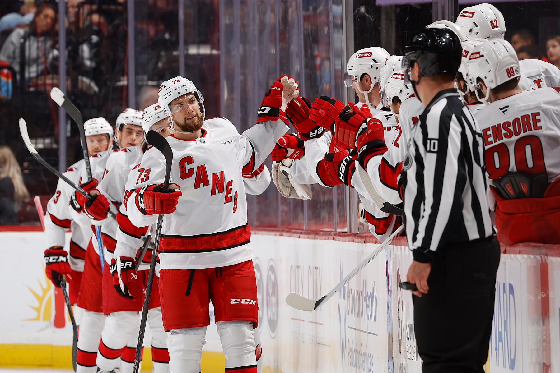 SUNRISE, FL - SEPTEMBER 28: Gleb Trikozov #73 of the Carolina Hurricanes skates by the team bench to celebrate with teammates after scoring a second period goal against the Florida Panthers during a preseason game at the Amerant Bank Arena on September 28, 2024 in Sunrise, Florida. (Photo by Joel Auerbach/Getty Images)