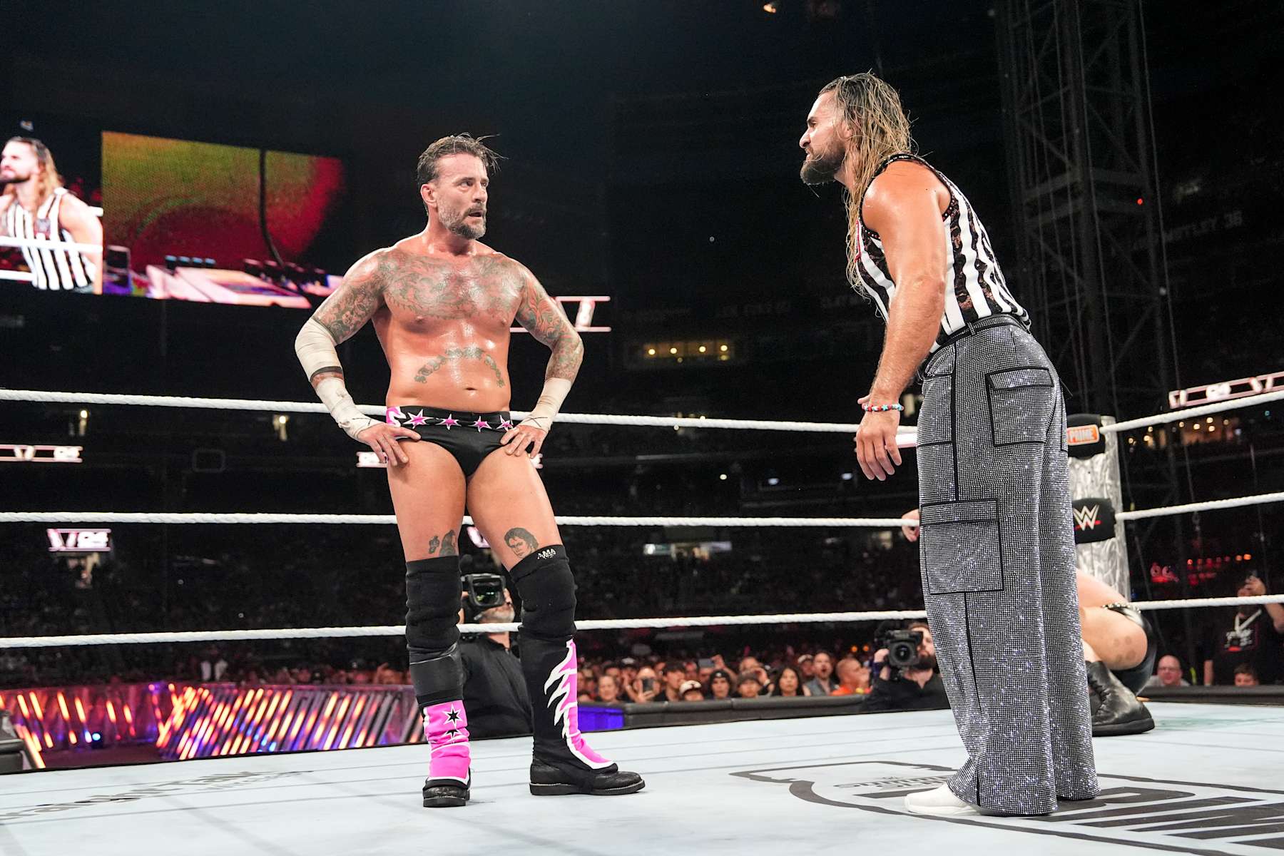 CLEVELAND, OHIO - AUGUST 03: CM Punk and Seth Rollins having words during SummerSlam at Cleveland Browns Stadium on August 3, 2024 in Cleveland, Ohio. (Photo by WWE/Getty Images)