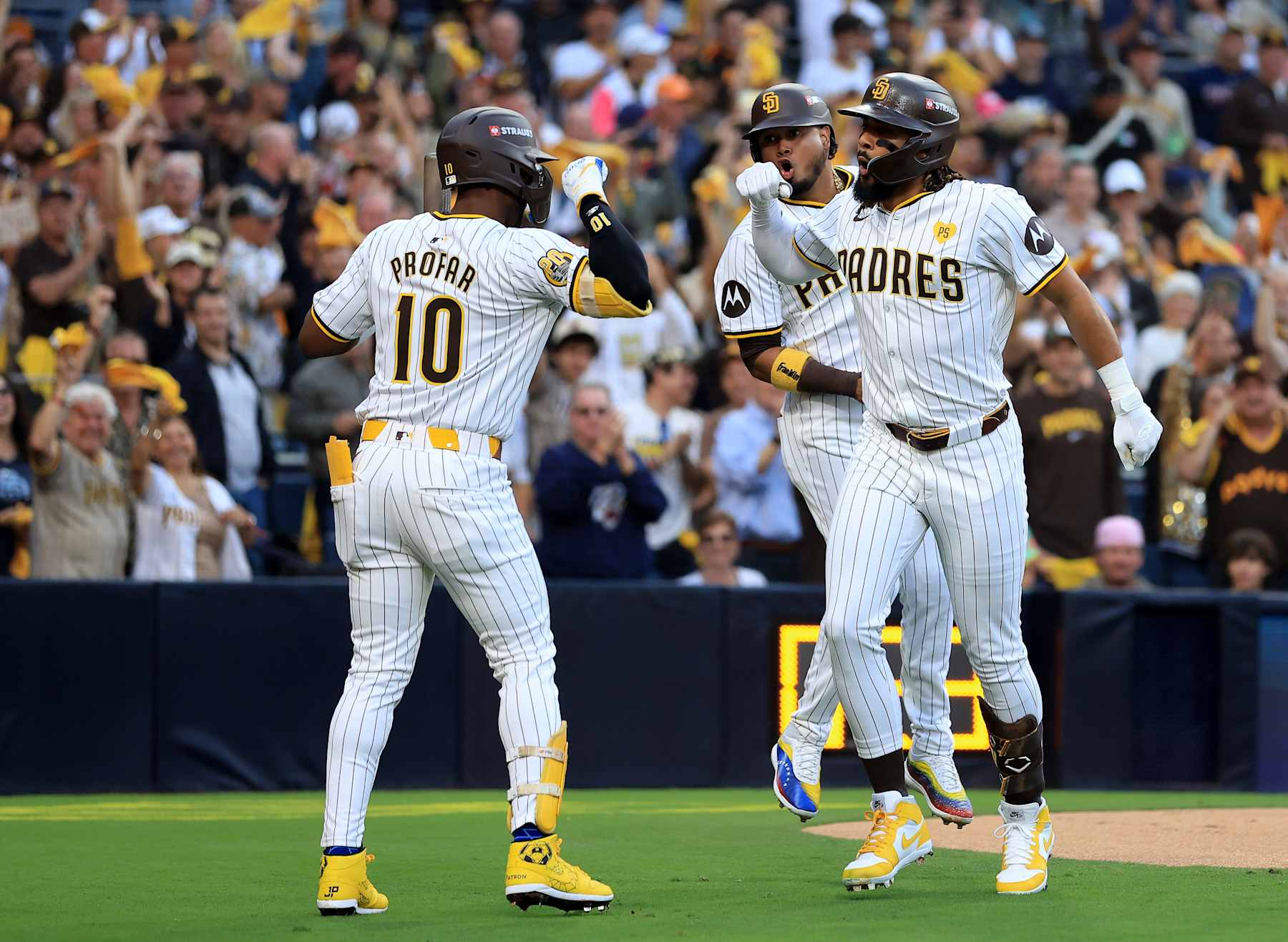 SAN DIEGO, CALIFORNIA - OCTOBER 01: Fernando Tatis Jr. #23 of the San Diego Padres celebrates with Jurickson Profar #10 after hitting a two run home run against AJ Smith-Shawver #32 of the Atlanta Braves during the first inning in Game One of the Wild Card Series at Petco Park on October 01, 2024 in San Diego, California. (Photo by Sean M. Haffey/Getty Images)