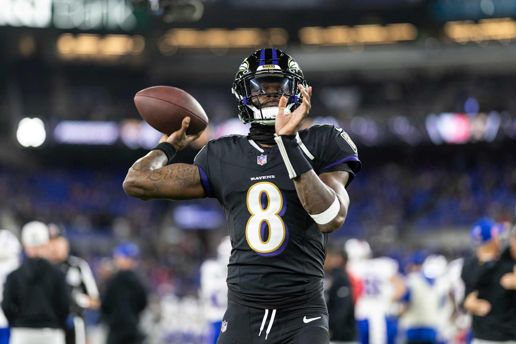 BALTIMORE, MARYLAND - SEPTEMBER 29: Lamar Jackson #8 of the Baltimore Ravens looks to pass as he warms up prior to an NFL football game against the Buffalo Bills at M&T Bank Stadium on September 29, 2024 in Baltimore, Maryland. (Photo by Michael Owens/Getty Images)