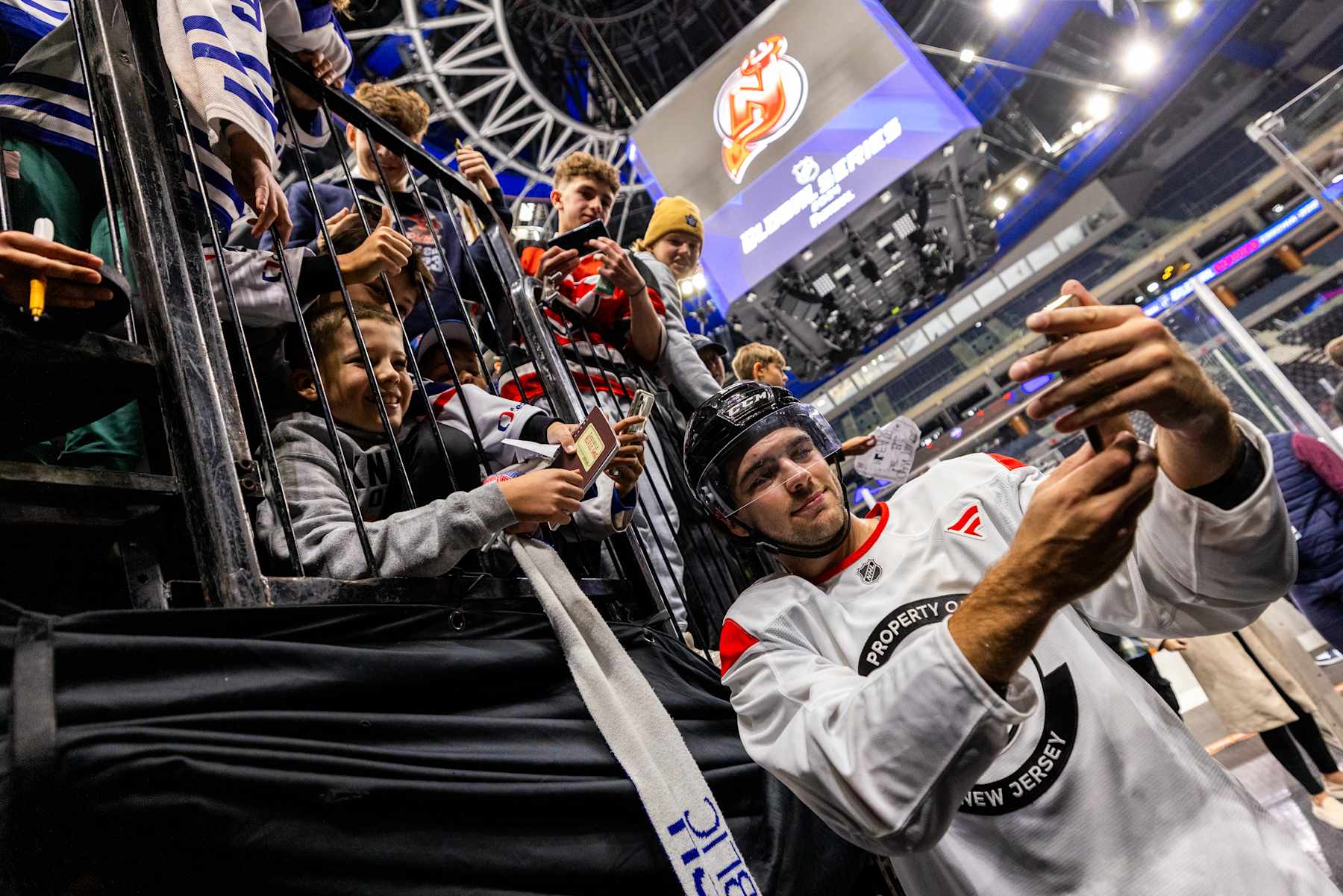 PRAGUE, CZECH REPUBLIC - OCTOBER 3: Nico Hischier #13 of the New Jersey Devils takes a photo with fans after practice prior to the 2024 NHL Global Series Challenge at O2 Arena on October 3, 2024 in Prague, Czech Republic. (Photo by Andrew Maclean/NHLI via Getty Images)