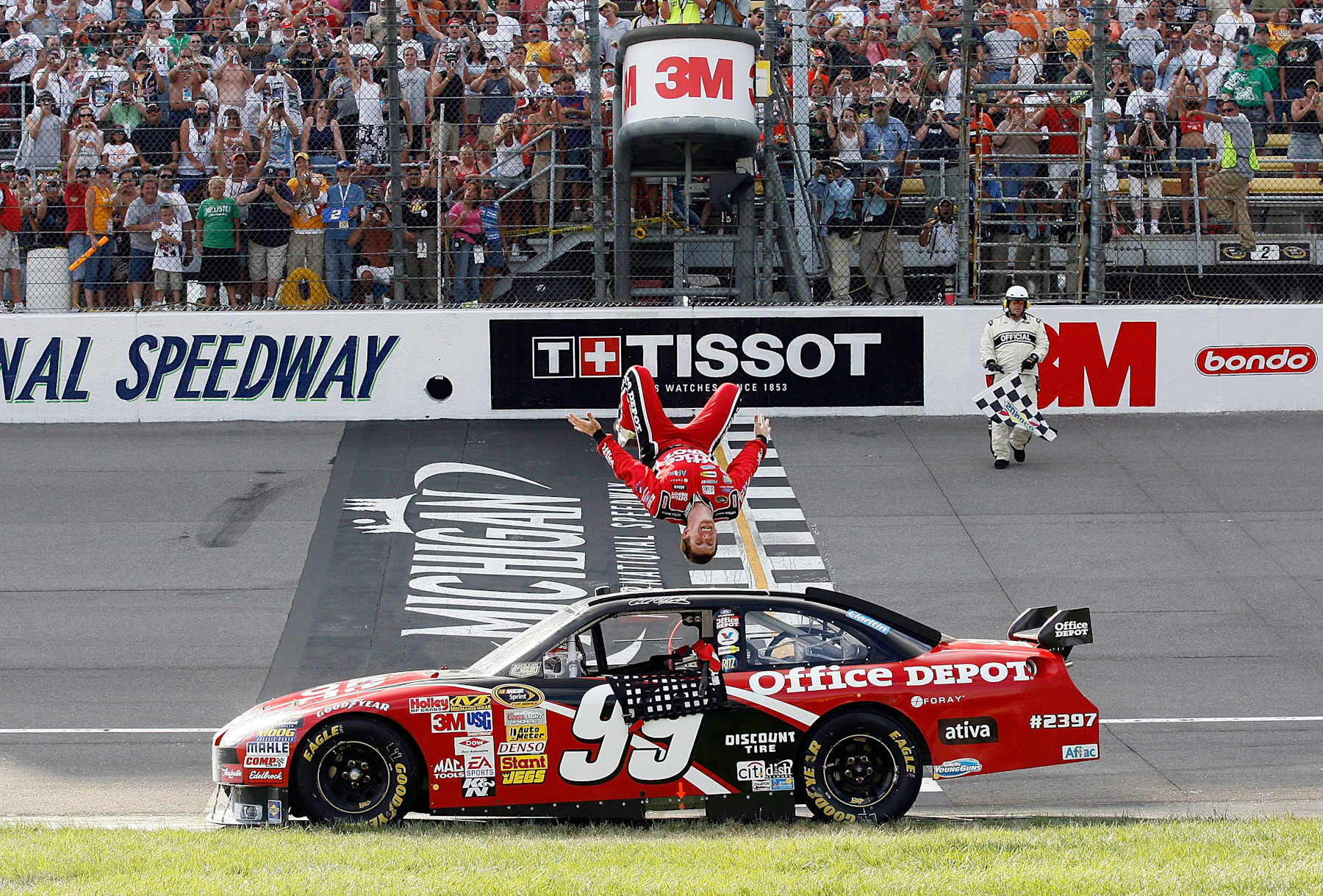 BROOKLYN, MI - AUGUST 17: Carl Edwards, driver of the #99 Office Depot Ford, celebrates with a backflip from his car after winning the NASCAR Sprint Cup Series 3M Performance 400 at Michigan International Speedway on August 17, 2008 in Brooklyn, Michigan. (Photo by Geoff Burke/Getty Images for NASCAR)