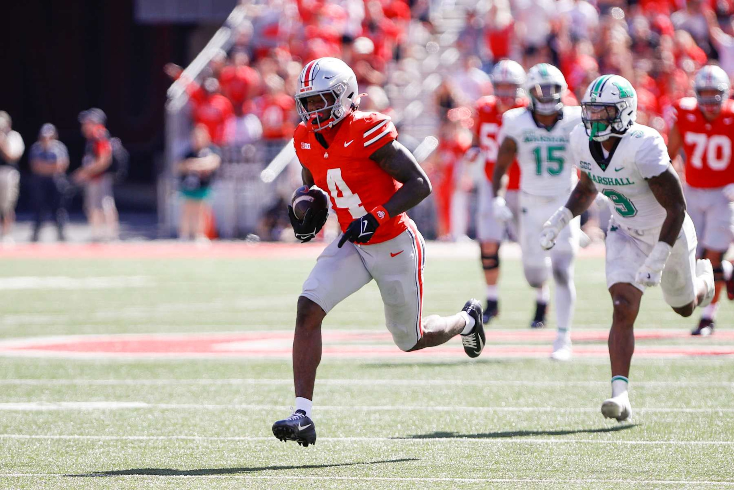 COLUMBUS, OH - SEPTEMBER 21: Ohio State Buckeyes wide receiver Jeremiah Smith (4) carries the ball for a touchdown during the game against Marshall Thundering Herd and the Ohio State Buckeyes on September 21, 2024, at Ohio Stadium in Columbus, OH. (Photo by Ian Johnson/Icon Sportswire via Getty Images)