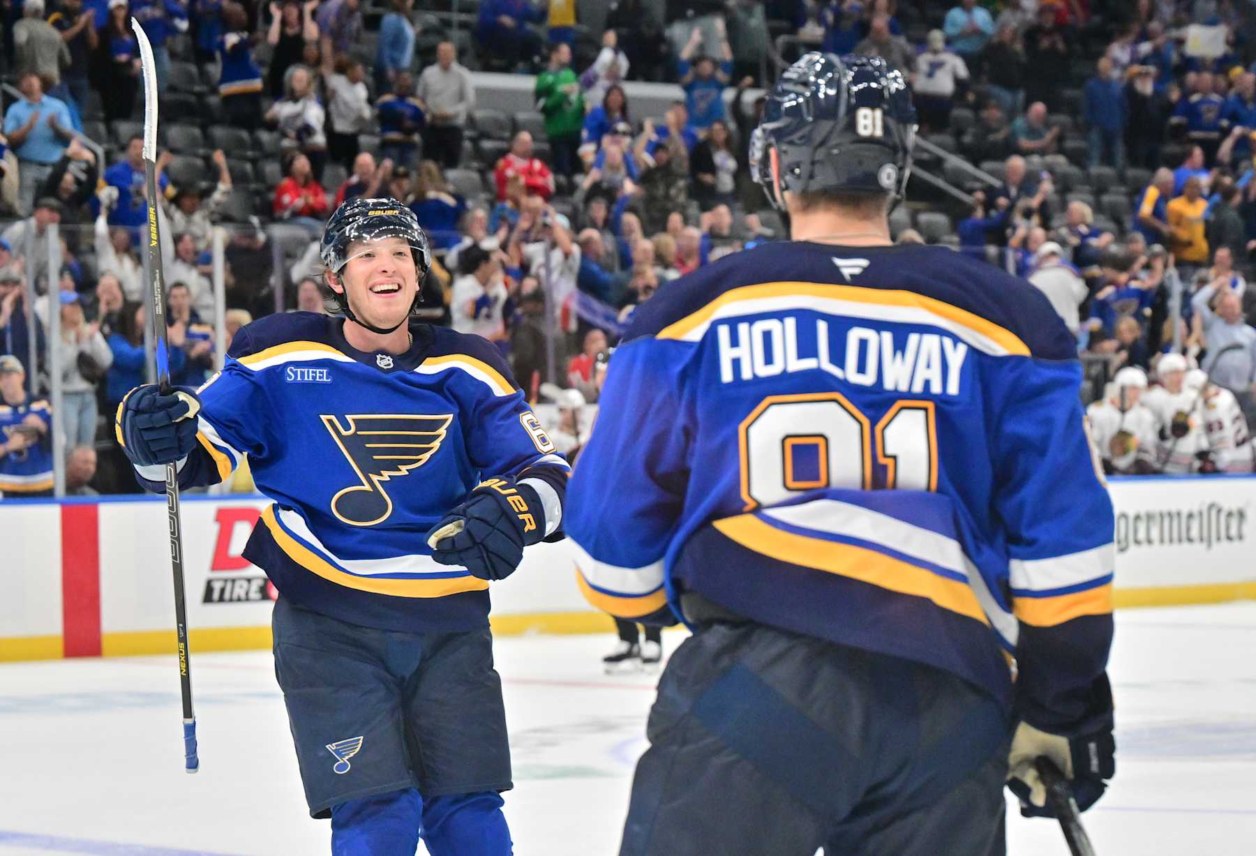ST. LOUIS, MO - SEPTEMBER 28: St. Louis Blues leftwing Jake Neighbors (63) congratulates St. Louis Blues center Dylan Holloway (81) after his game-winning goal in overtime after a preseason NHL game between the Chicago Blackhawks and the St. Louis Blues, on September 28, 2024, at Enterprise Center, St. Louis, MO. (Photo by Keith Gillett/IconSportswire)