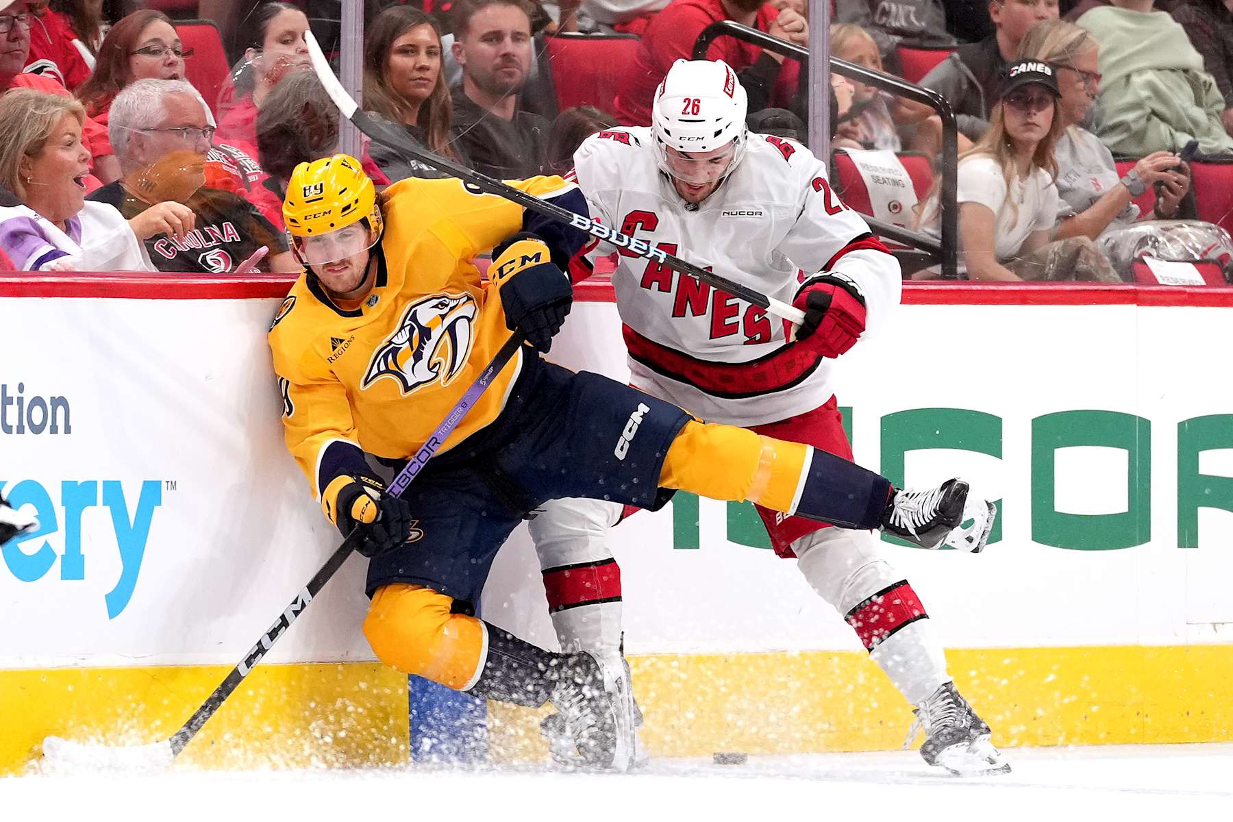 RALEIGH, NORTH CAROLINA - OCTOBER 02: Ozzy Wiesblatt #89 of the Nashville Predators battles Sean Walker #26 of the Carolina Hurricanes for the puck during a preseason game at Lenovo Center on October 02, 2024 in Raleigh, North Carolina. (Photo by Grant Halverson/Getty Images)