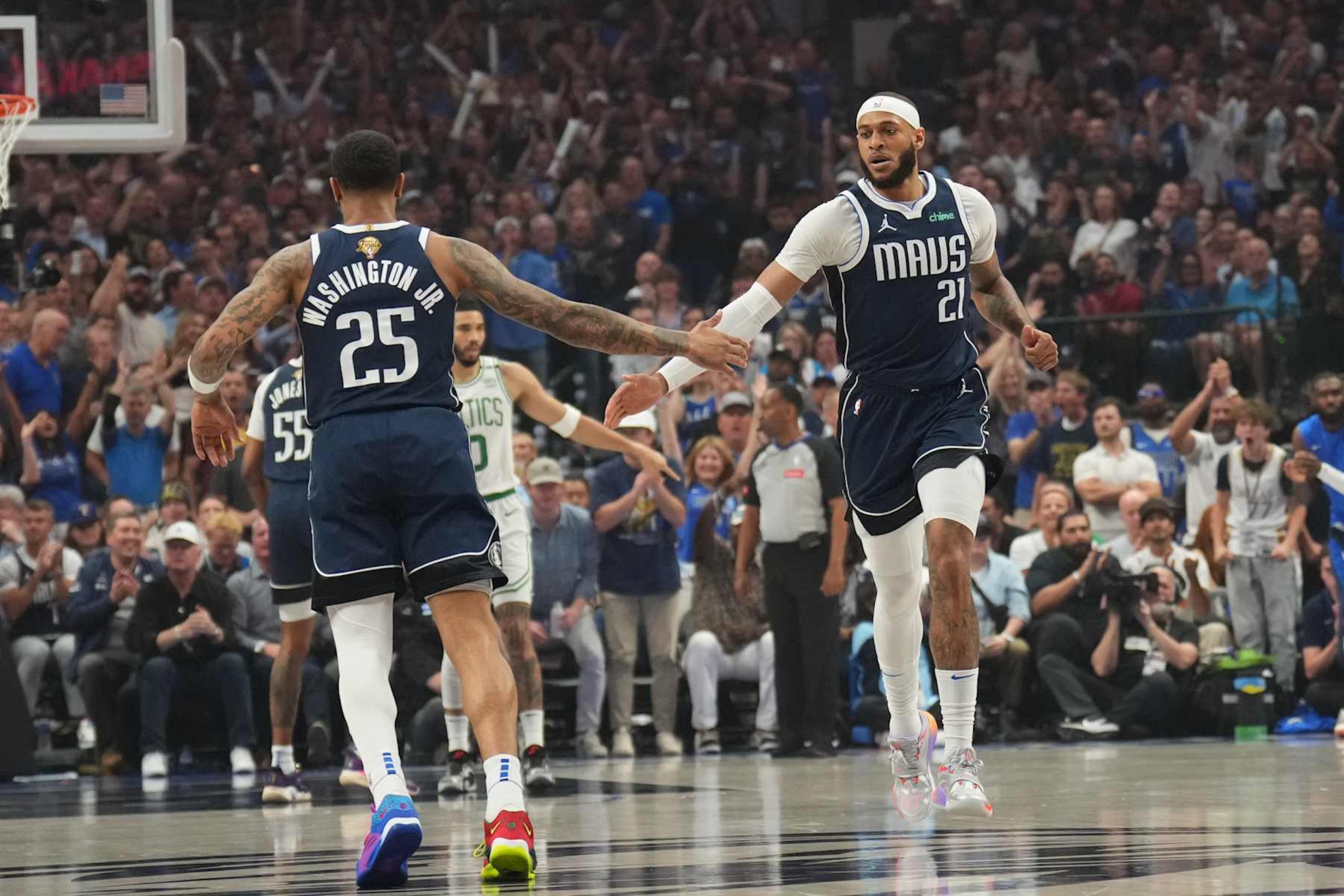 DALLAS, TX - JUNE 12: Daniel Gafford #21 high fives PJ Washington #25 of the Dallas Mavericks during the game against the Boston Celtics during Game 3 of the 2024 NBA Finals on June 12, 2024 at the American Airlines Center in Dallas, Texas. NOTE TO USER: User expressly acknowledges and agrees that, by downloading and or using this photograph, User is consenting to the terms and conditions of the Getty Images License Agreement. Mandatory Copyright Notice: Copyright 2024 NBAE (Photo by Jesse D. Garrabrant/NBAE via Getty Images)