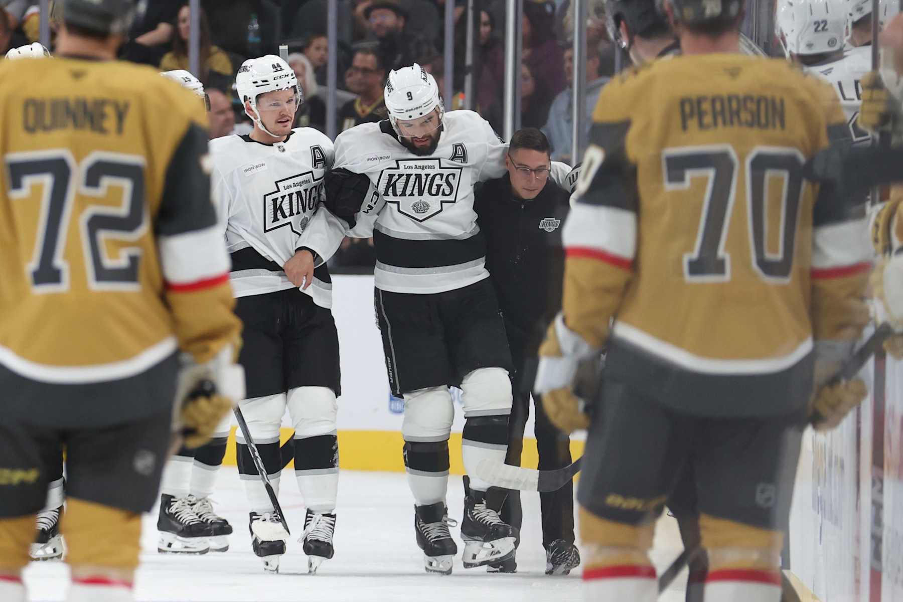 Los Angeles Kings defenseman Drew Doughty is helped off the ice after fracturing his left ankle.