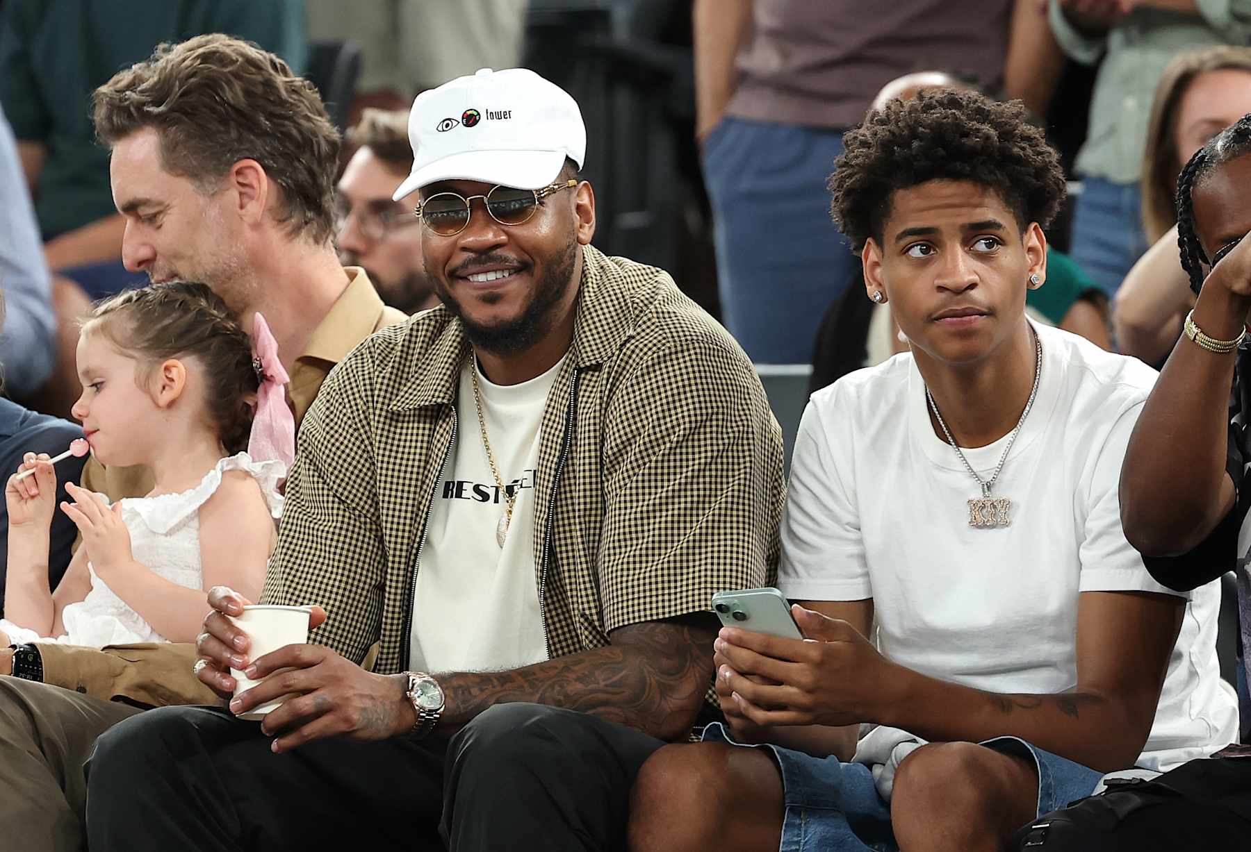 PARIS, FRANCE - AUGUST 06: Former NBA player Carmelo Anthony and Kiyan Anthony watch a Men's basketball quarterfinal game between Team Canada and Team France on day eleven of the Olympic Games Paris 2024 at Bercy Arena on August 06, 2024 in Paris, France. (Photo by Jamie Squire/Getty Images)