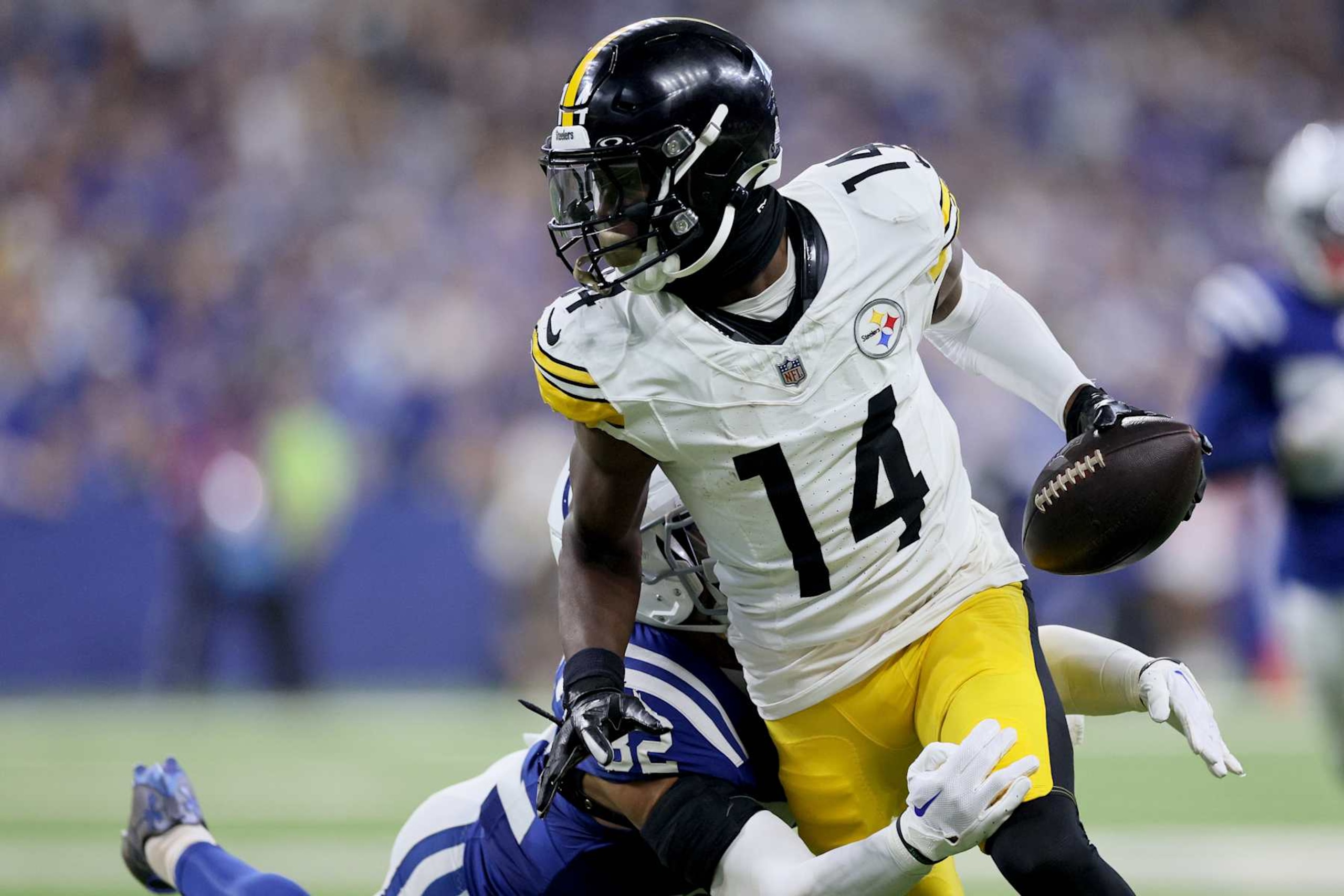 INDIANAPOLIS, INDIANA - SEPTEMBER 29: George Pickens (14) of the Pittsburgh Steelers is tackled by Julian Blackmon (32) of the Indianapolis Colts at Lucas Oil Stadium on September 29, 2024 in Indianapolis, Indiana. (Photo by Andy Lyons/Getty Images)