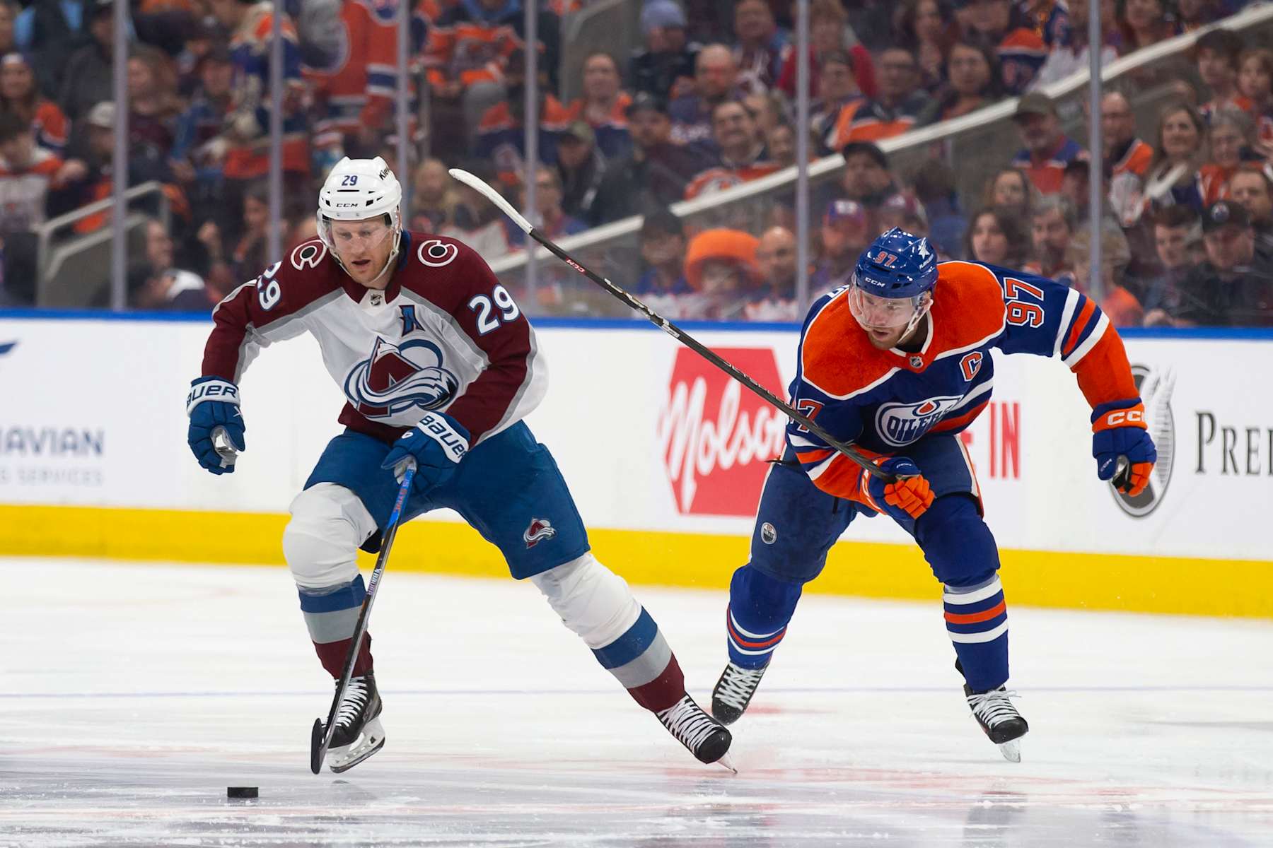 EDMONTON, CANADA - APRIL 5: Connor McDavid #97 of the Edmonton Oilers skates against Nathan MacKinnon #29 of the Colorado Avalanche during the first period at Rogers Place on April 5, 2024 in Edmonton, Canada. (Photo by Codie McLachlan/Getty Images)