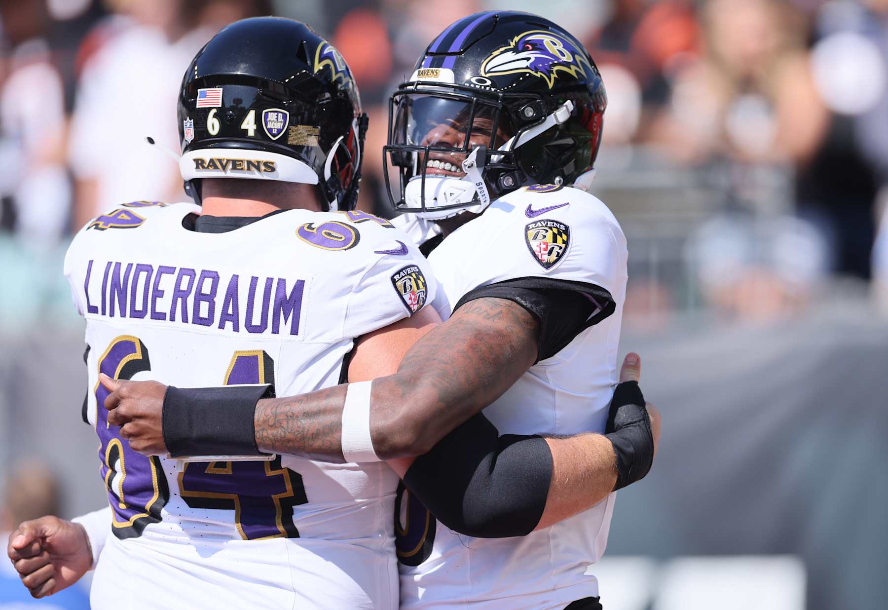 CINCINNATI, OHIO - OCTOBER 06: Tyler Linderbaum #64 and Lamar Jackson #8 of the Baltimore Ravens embrace before the game against the Cincinnati Bengals at Paycor Stadium on October 06, 2024 in Cincinnati, Ohio. (Photo by Andy Lyons/Getty Images)