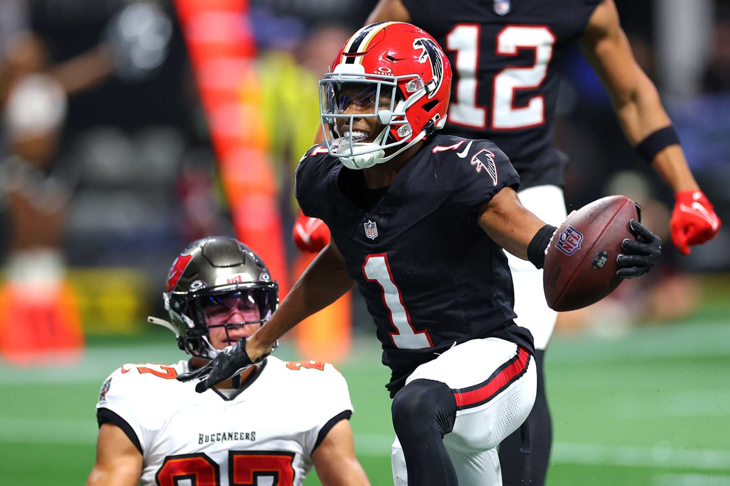 ATLANTA, GEORGIA - OCTOBER 03: Darnell Mooney #1 of the Atlanta Falcons celebrates after scoring a touchdown pass against Zyon McCollum #27 of the Tampa Bay Buccaneers during the second quarter at Mercedes-Benz Stadium on October 03, 2024 in Atlanta, Georgia. (Photo by Kevin C. Cox/Getty Images)