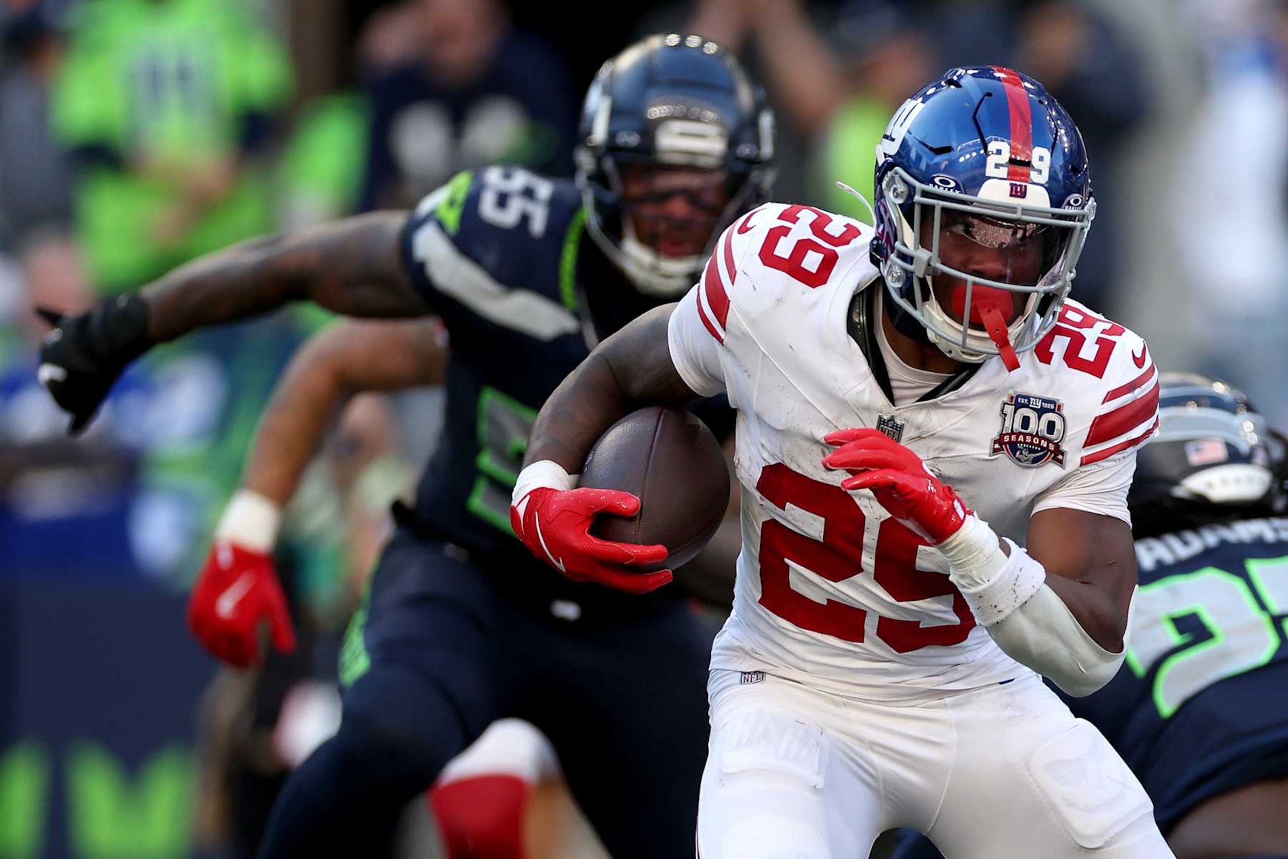 SEATTLE, WASHINGTON - OCTOBER 06: Tyrone Tracy Jr. #29 of the New York Giants carries the ball against the Seattle Seahawks at Lumen Field on October 06, 2024 in Seattle, Washington. (Photo by Steph Chambers/Getty Images)