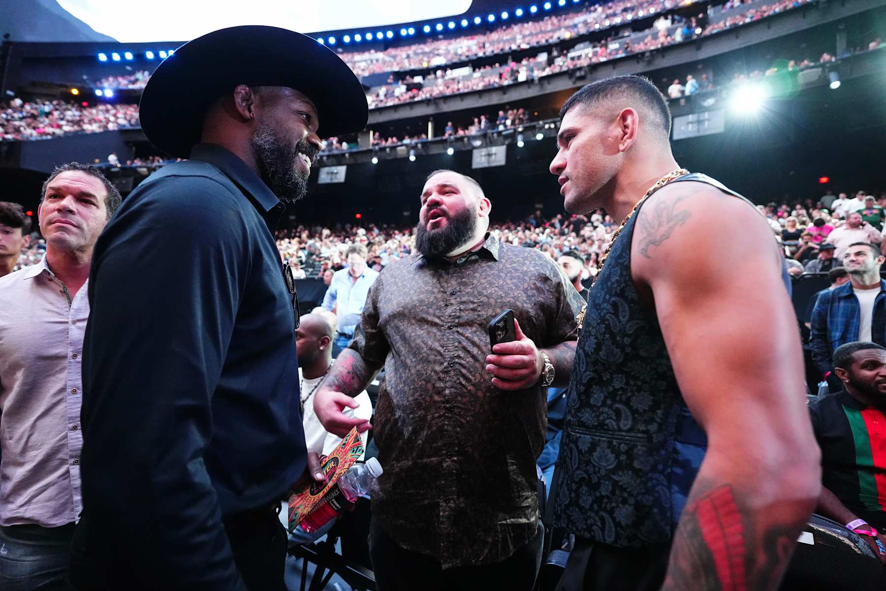 From left, UFC champions Jon Jones and Alex Pereira have a conversation at UFC 306.