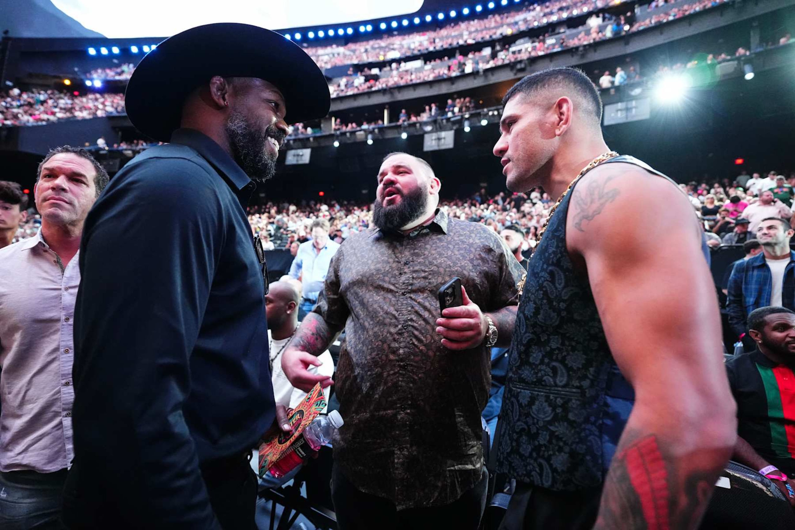 From left, UFC champions Jon Jones and Alex Pereira have a conversation at UFC 306.