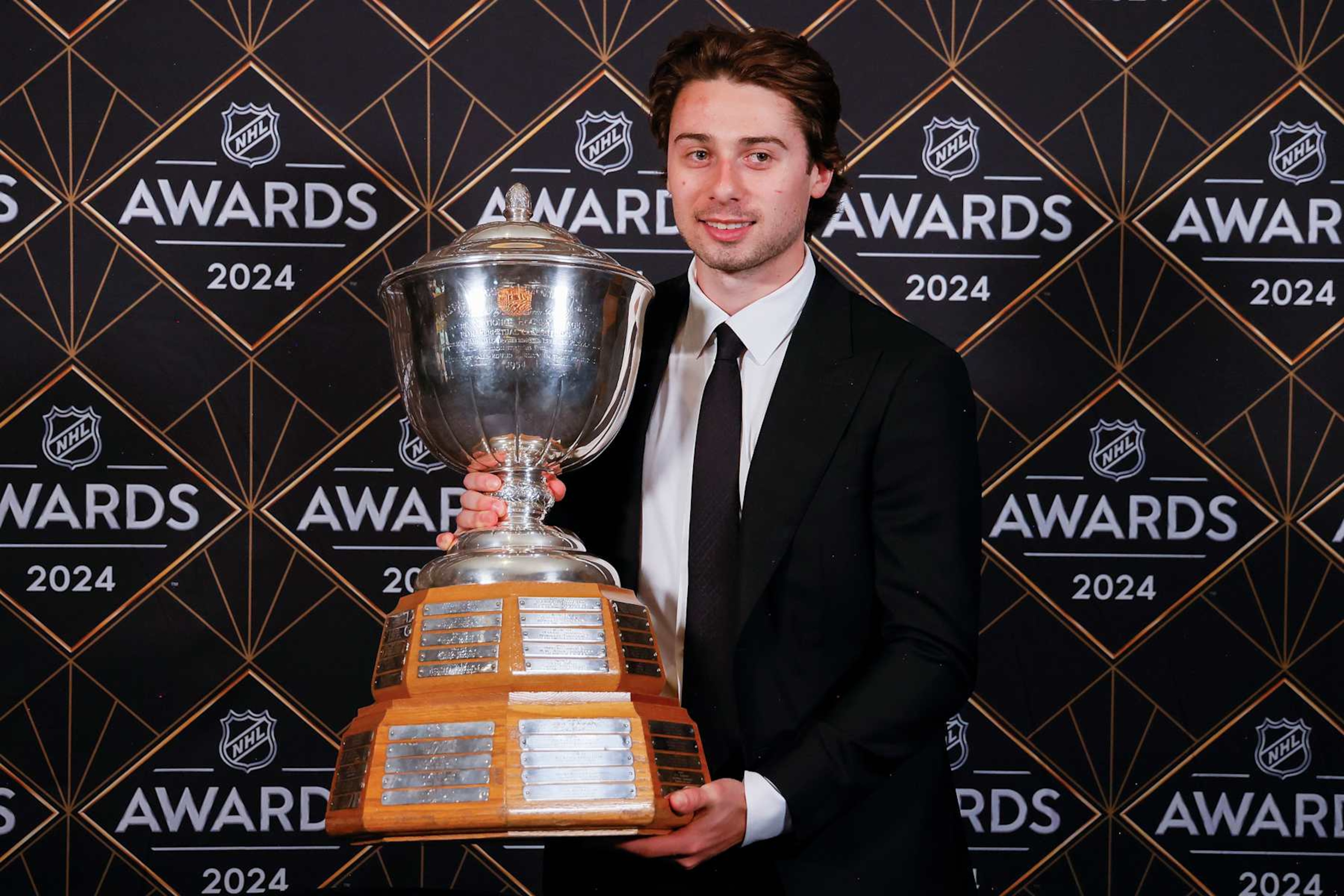 Quinn Hughes with the James Norris Memorial Trophy. Quinn Hughes with the James Norris Memorial Trophy.