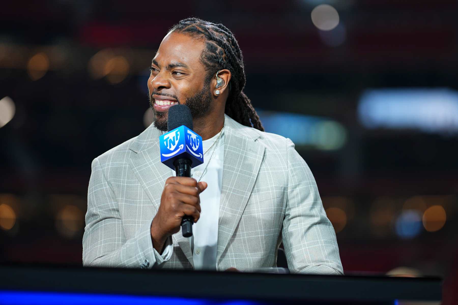 ATLANTA, GA - OCTOBER 03: Richard Sherman looks on from the TNF on Prime set prior to an NFL football game between the Tampa Bay Buccaneers and the Atlanta Falcons at Mercedes-Benz Stadium on October 3, 2024 in Atlanta, Georgia. (Photo by Cooper Neill/Getty Images)