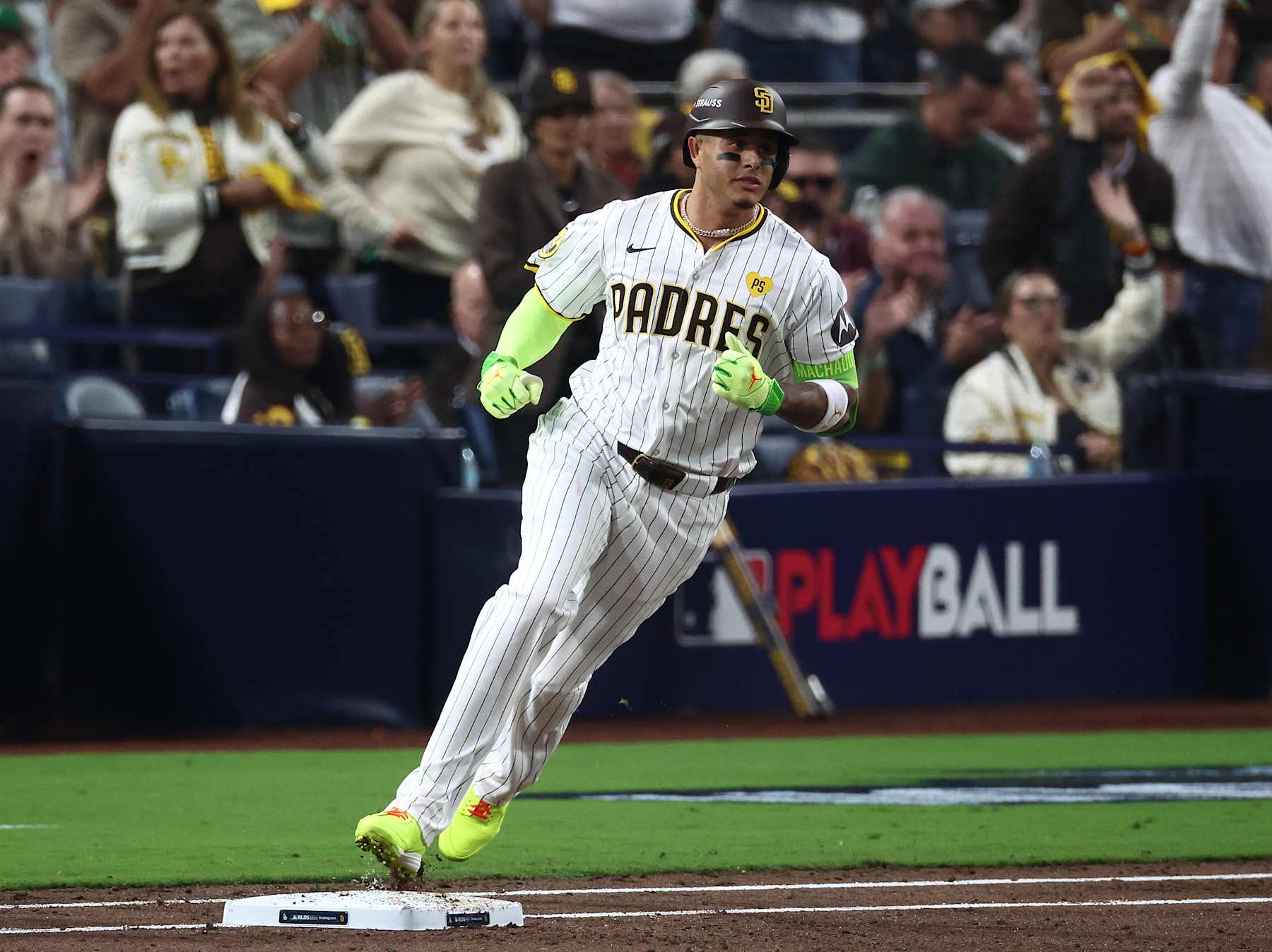 SAN DIEGO, CALIFORNIA - OCTOBER 08: Manny Machado #13 of the San Diego Padres reaches first base for a single in the second inning against the Los Angeles Dodgers during Game Three of the Division Series at Petco Park on October 08, 2024 in San Diego, California. (Photo by Katelyn Mulcahy/Getty Images)