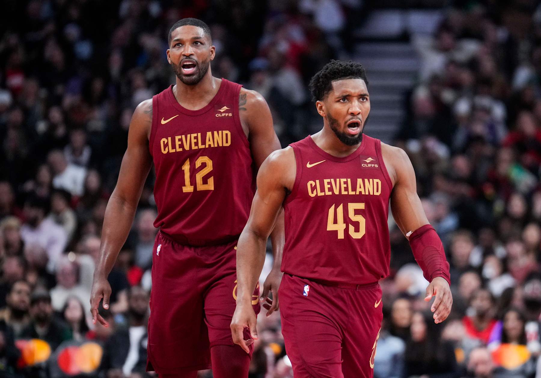 TORONTO, ON - JANUARY 1: Tristan Thompson #12 and Donovan Mitchell #45 of Cleveland Cavaliers celebrate against the Toronto Raptors during the second half of their basketball game at the Scotiabank Arena on January 1, 2024 in Toronto, Ontario, Canada. NOTE TO USER: User expressly acknowledges and agrees that, by downloading and/or using this Photograph, user is consenting to the terms and conditions of the Getty Images License Agreement. (Photo by Mark Blinch/Getty Images)