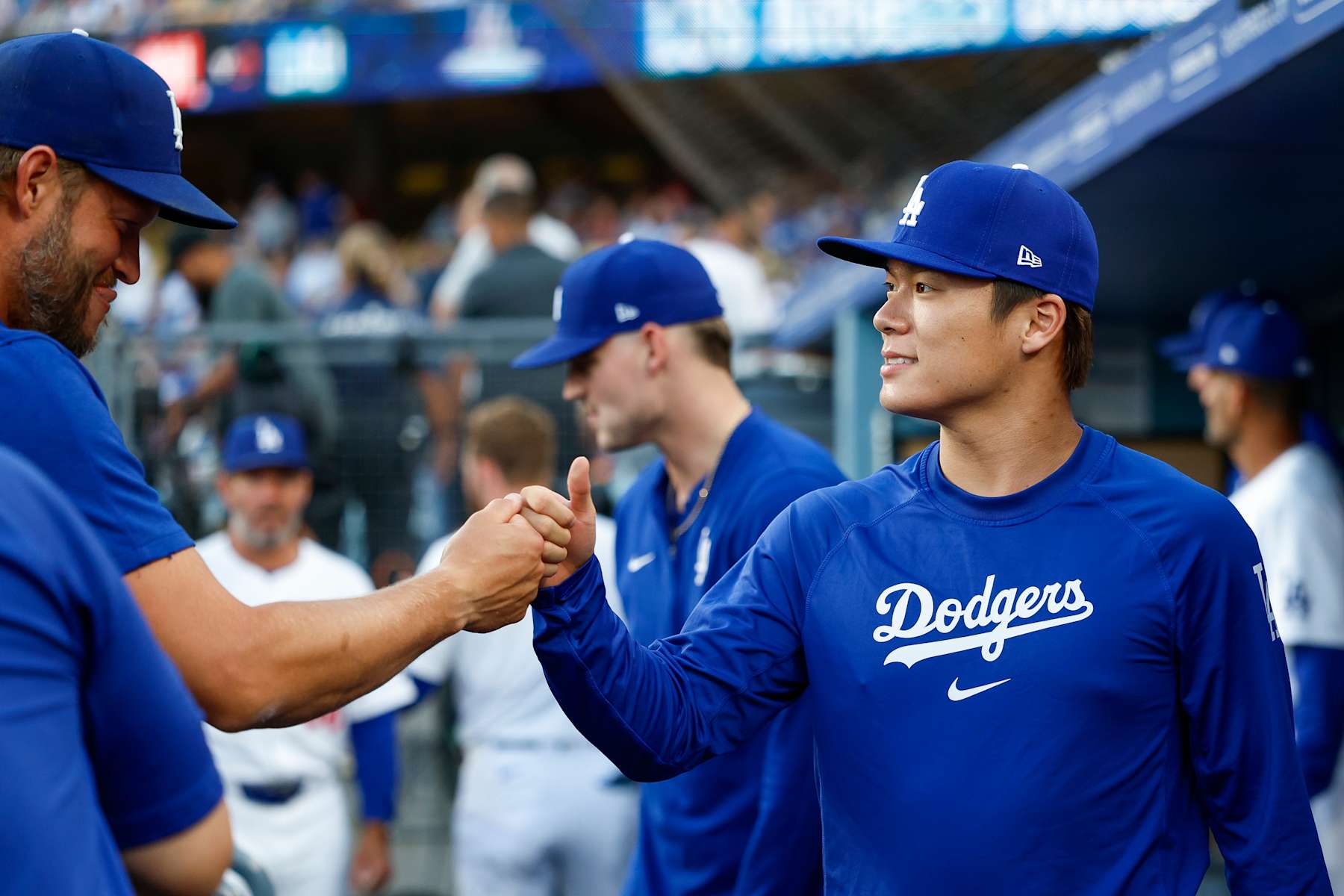 LOS ANGELES, CALIFORNIA - AUGUST 7: Yoshinobu Yamamoto #18 of the Los Angeles Dodgers fist bumps Clayton Kershaw #22 prior to a game against the Philadelphia Phillies at Dodger Stadium on August 7, 2024 in Los Angeles, California. (Photo by Brandon Sloter/Image Of Sport/Getty Images)