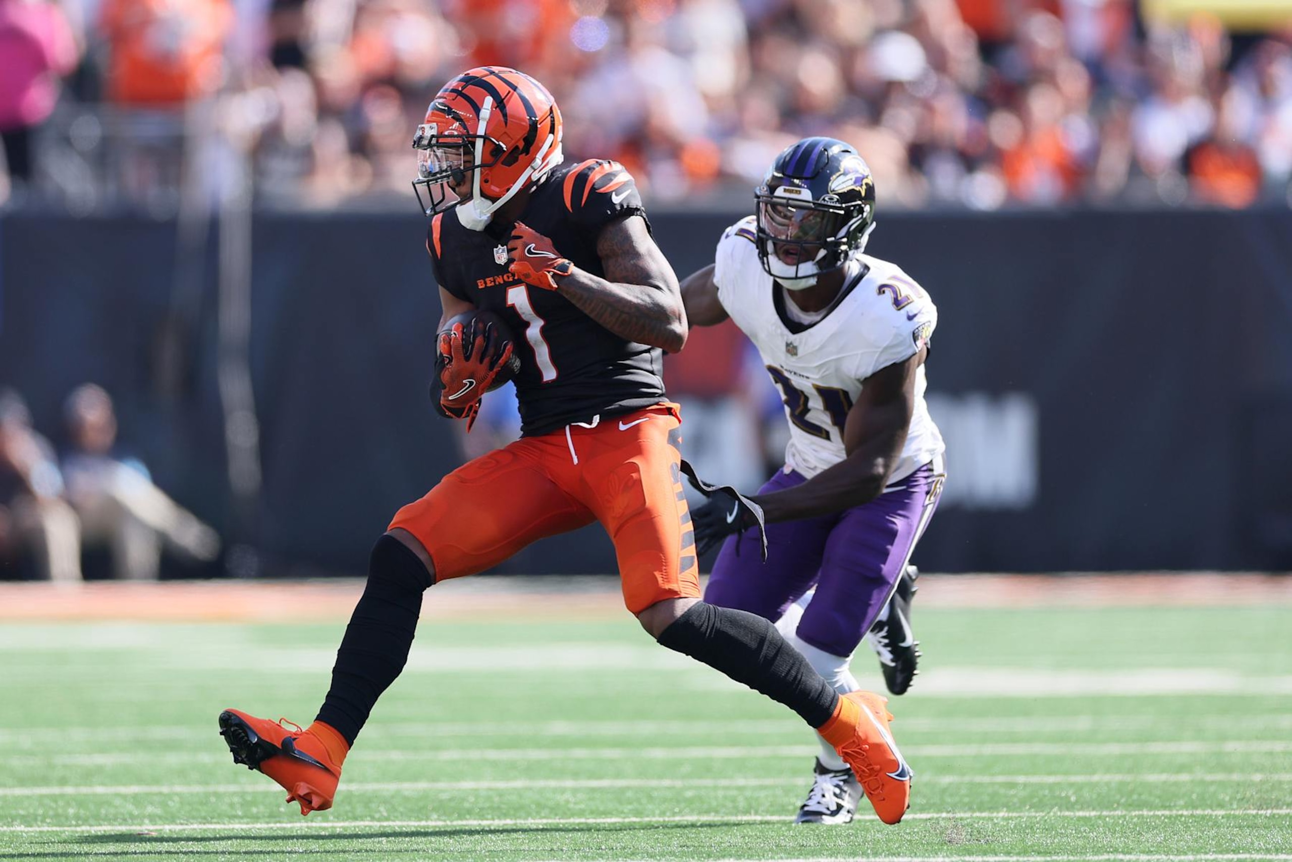 CINCINNATI, OHIO - OCTOBER 06: Ja'Marr Chase #1 of the Cincinnati Bengals runs after a catch as Brandon Stephens #21 of the Baltimore Ravens pursues a tackle during the fourth quarter at Paycor Stadium on October 06, 2024 in Cincinnati, Ohio. (Photo by Andy Lyons/Getty Images) CINCINNATI, OHIO - OCTOBER 06: Ja'Marr Chase #1 of the Cincinnati Bengals runs after a catch as Brandon Stephens #21 of the Baltimore Ravens pursues a tackle during the fourth quarter at Paycor Stadium on October 06, 2024 in Cincinnati, Ohio. (Photo by Andy Lyons/Getty Images)