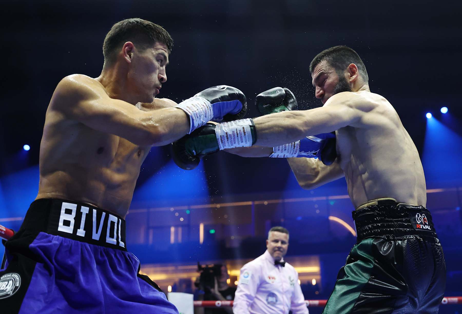 RIYADH, SAUDI ARABIA - OCTOBER 12: Dmitrii Bivol punches Artur Beterbiev during the IBF, IBO, WBC and WBO World Light Heavyweight titles' fight between Artur Beterbiev and Dmitrii Bivol as part of the Riyadh Season - IV Crown Showdown card at Kingdom Arena on October 12, 2024 in Riyadh. (Photo by Richard Pelham/Getty Images)