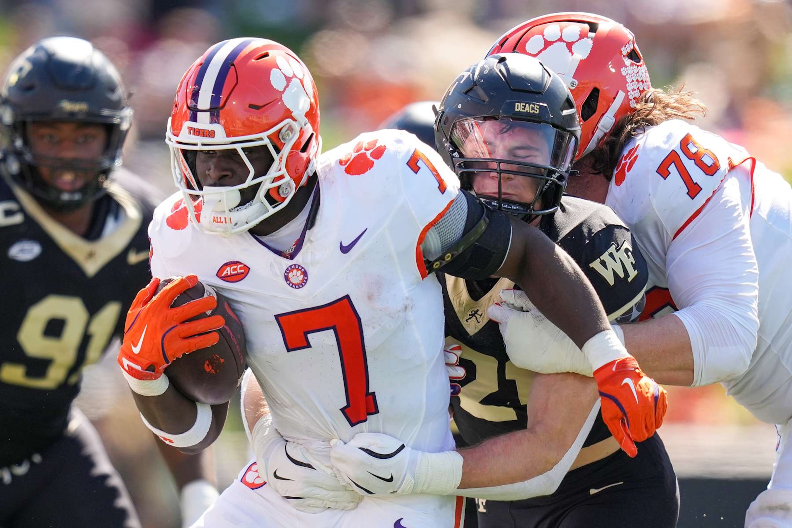 WINSTON-SALEM, NORTH CAROLINA - OCTOBER 12: Branson Combs #21 of the Wake Forest Demon Deacons attempts to tackle Phil Mafah #7 of the Clemson Tigers during the first half of the game at Truist Field on October 12, 2024 in Winston-Salem, North Carolina. (Photo by Grant Halverson/Getty Images) WINSTON-SALEM, NORTH CAROLINA - OCTOBER 12: Branson Combs #21 of the Wake Forest Demon Deacons attempts to tackle Phil Mafah #7 of the Clemson Tigers during the first half of the game at Truist Field on October 12, 2024 in Winston-Salem, North Carolina. (Photo by Grant Halverson/Getty Images)