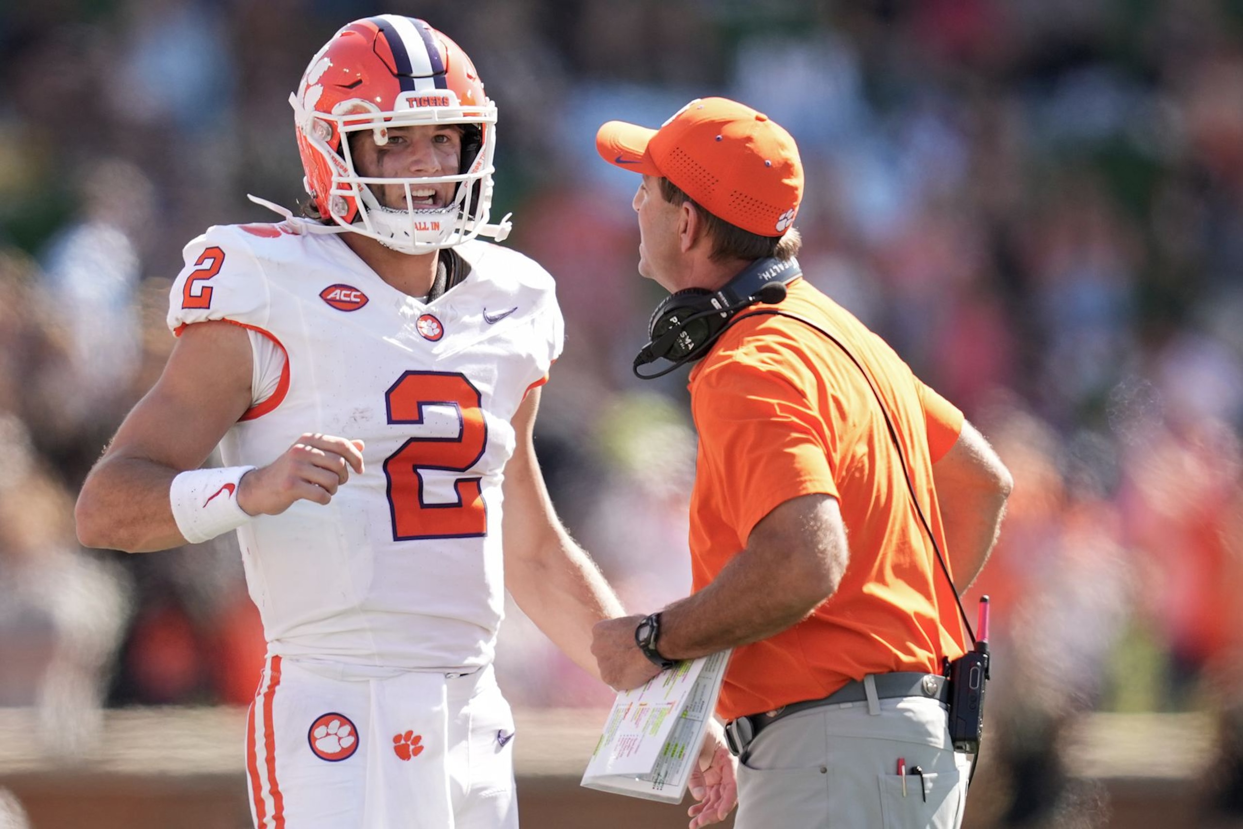 WINSTON-SALEM, NORTH CAROLINA - OCTOBER 12: Cade Klubnik #2 talks with head coach Dabo Swinney of the Clemson Tigers during the first half of the game against the Wake Forest Demon Deacons at Truist Field on October 12, 2024 in Winston-Salem, North Carolina.  (Photo by Grant Halverson/Getty Images)