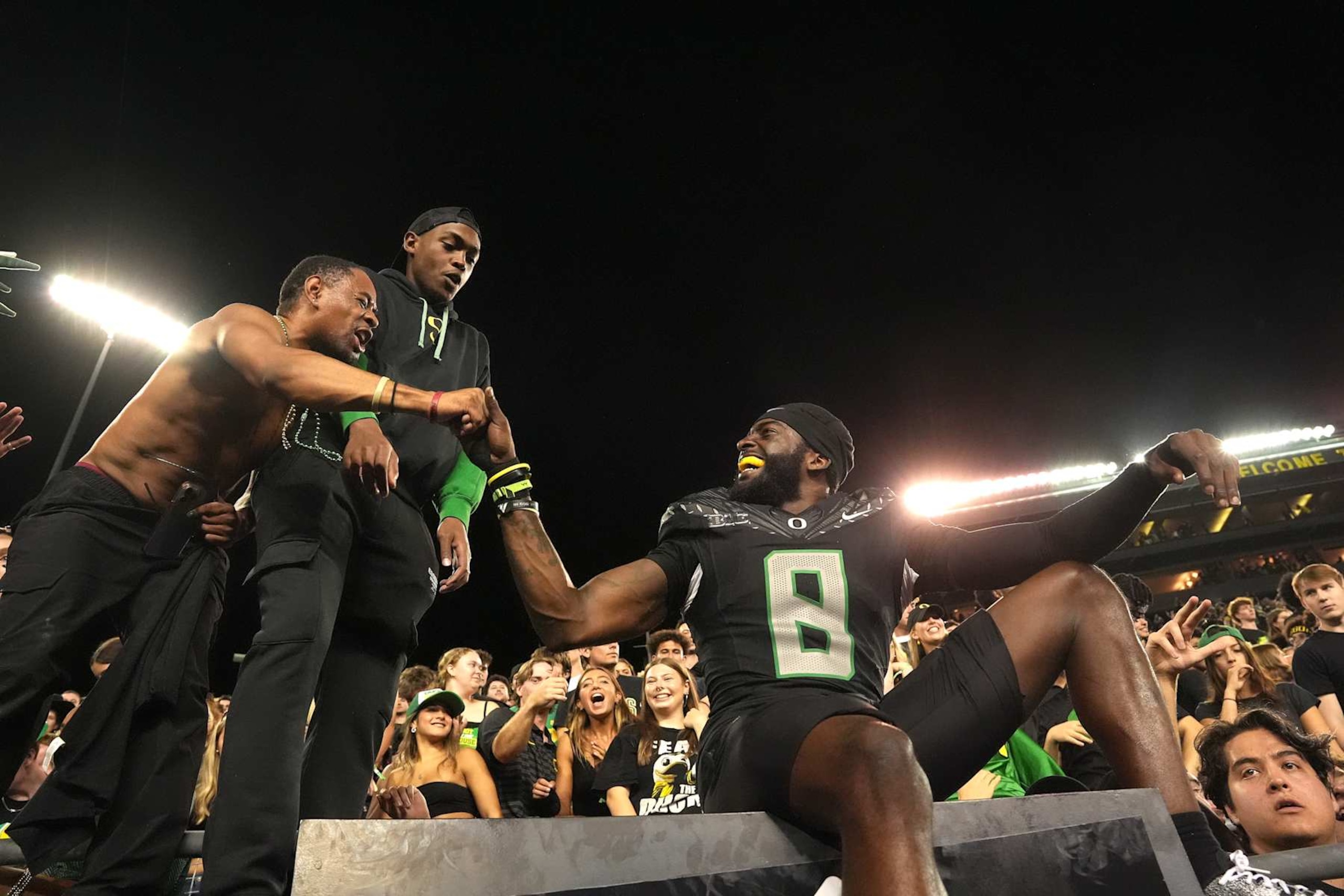 EUGENE, OREGON - OCTOBER 12: Dontae Manning #8 of the Oregon Ducks celebrates with fans after defeating the Ohio State Buckeyes 32-31 at Autzen Stadium on October 12, 2024 in Eugene, Oregon. (Photo by Ali Gradischer/Getty Images)